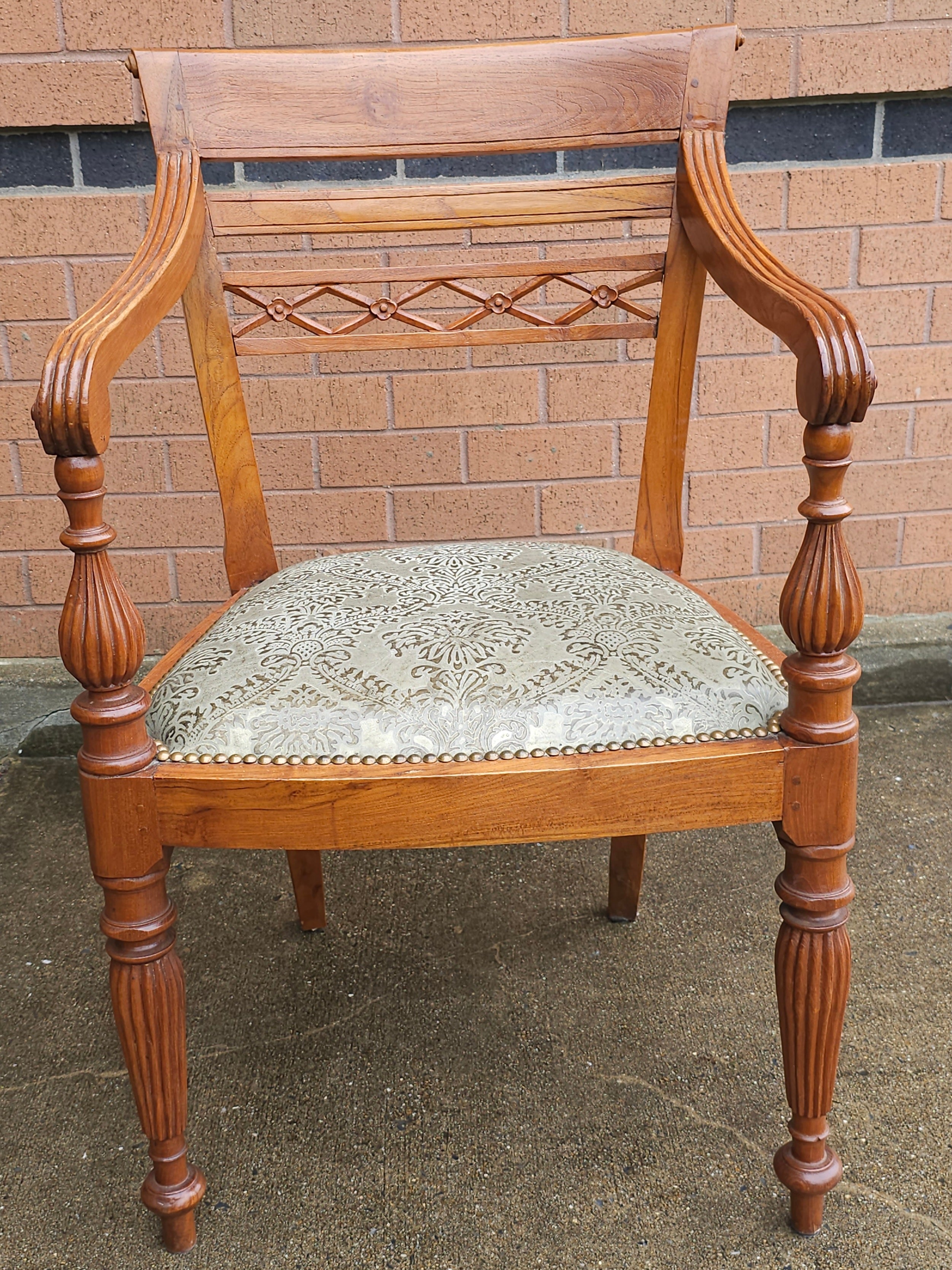 An Anglo Indian Style  Teak and Upholstered with Nailhead Trims Armchair. Measures 23.5
