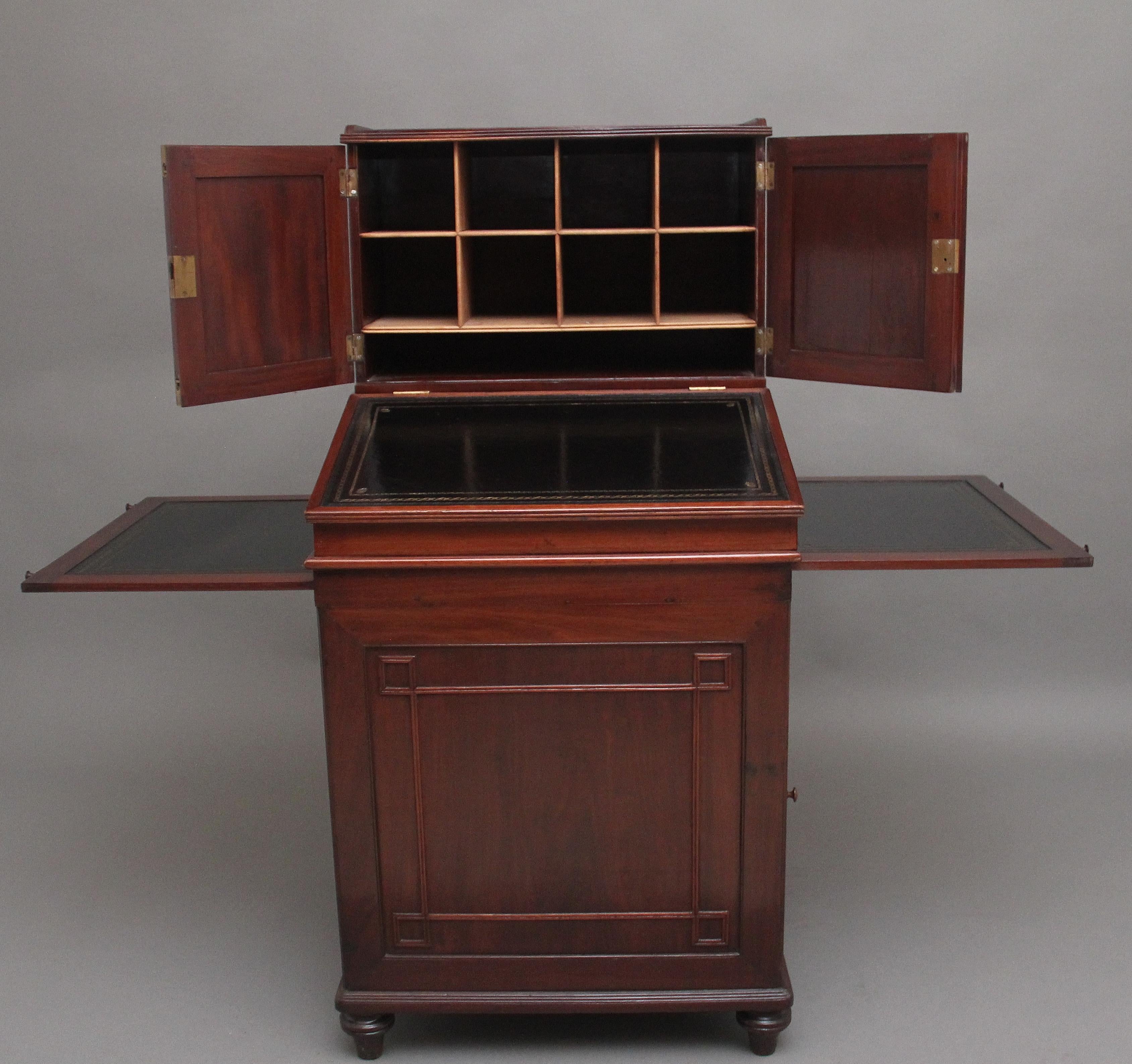 A good quality mid 20th Century teak davenport, the top structure having two panelled hinged doors opening to reveal various compartments, the desk section having a panelled hinged door opening to reveal an arrangement of four graduated drawers with