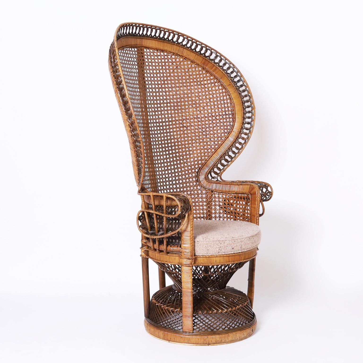 Vintage British Colonial style peacock chair crafted in wicker and rattan with a natural and stained palette on a classic exotic form.