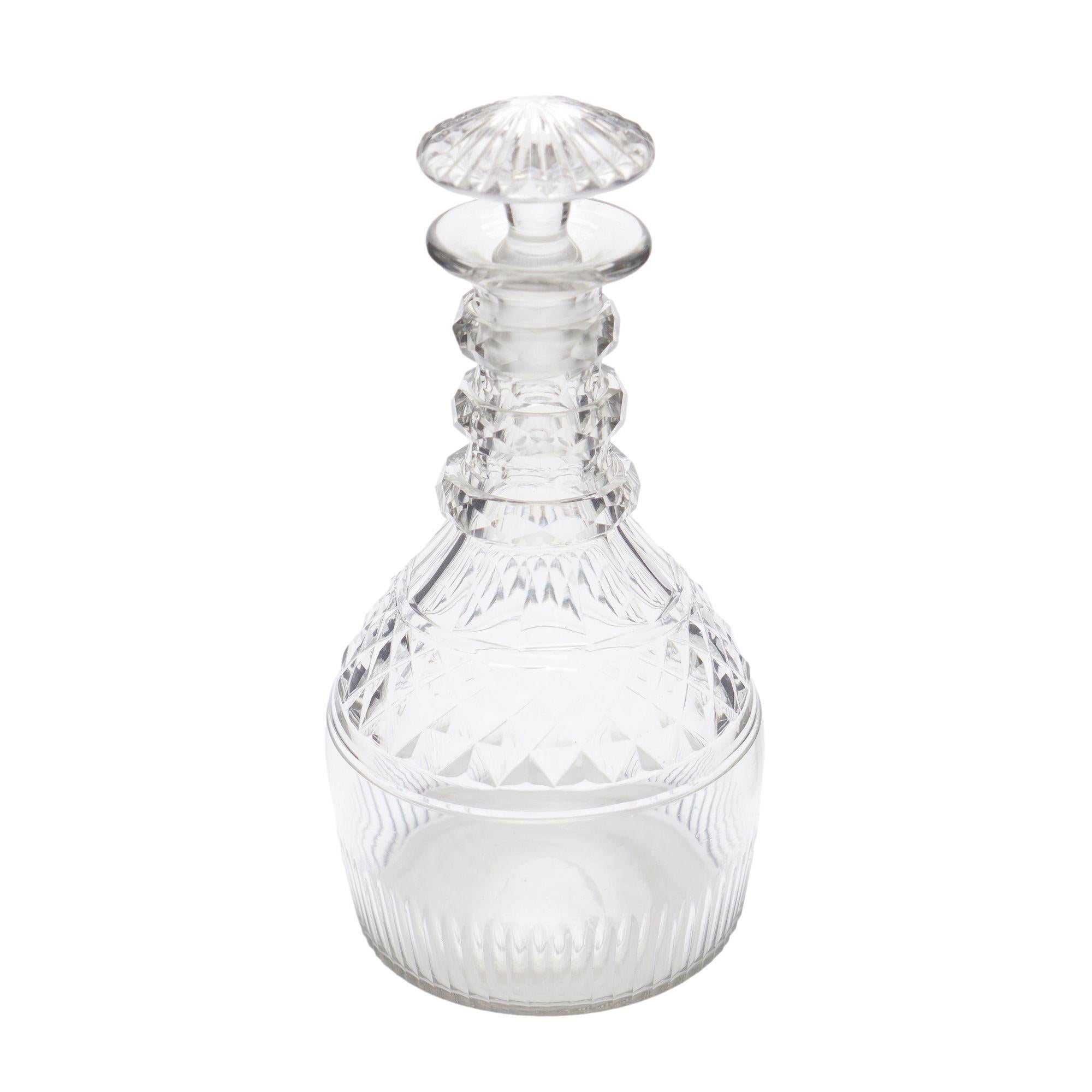 Pear shaped blown & cut glass decanter with three cut neck rings over a strawberry point and ray cut body. Fitted with a blown & ray cut mushroom stopper.
Anglo-Irish, circa 1790-1810.

Dimensions: 4-1/4