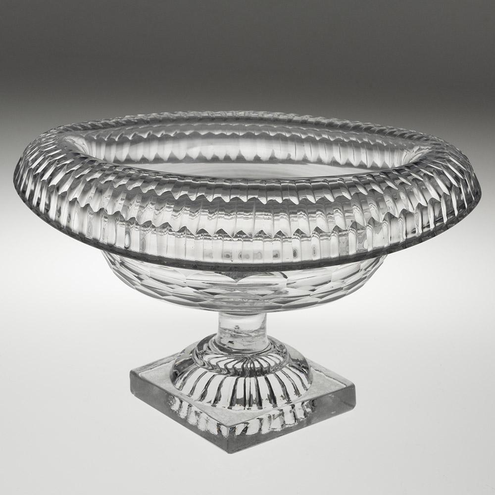 Heading : Anglo-Irish glass bowl with lemon squeezer foot c1790
Period : George III
Origin : Ireland
Colour : Clear
Bowl : Prismatic split cuts of graduated size on the rim. honeycomb cut band to body
Stem : Capstan
Foot : Square base lemon