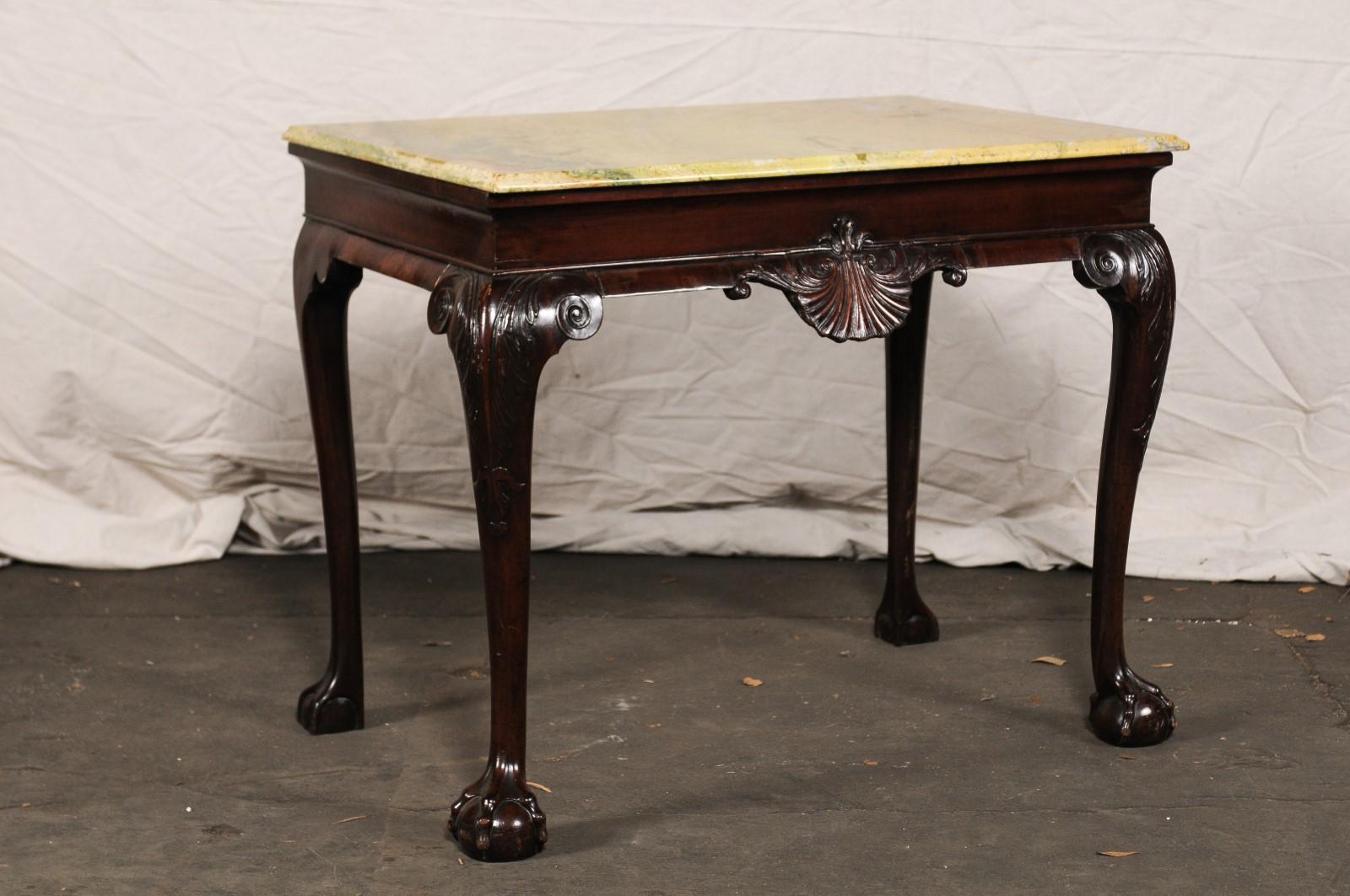 Probably 18th century Anglo-Irish mahogany slab serving table with shell motif, paw feet.