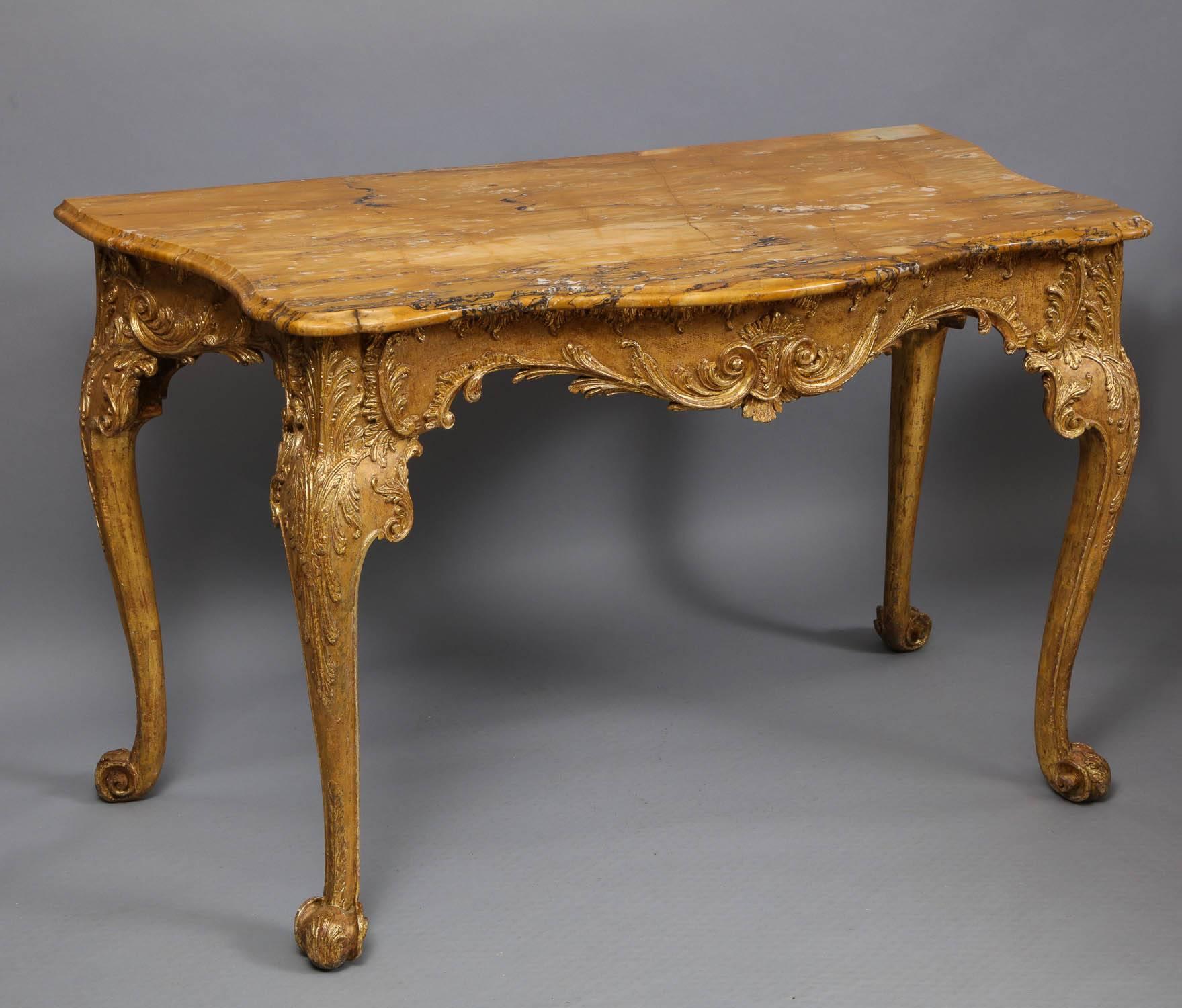 Fine 18th century Irish console table, the shaped Siena top with ogee edge over serpentine shaped frame having foliate and rocaille carving, the cabriole legs ending in leaf carved richly scrolled legs, retaining much original gilding, the top 18th