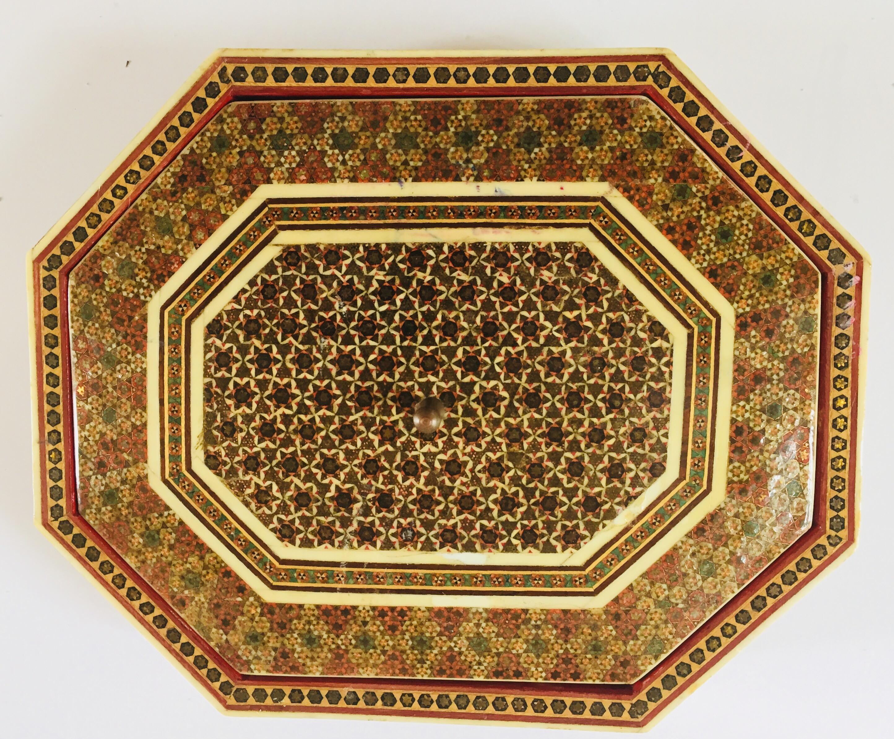 Anglo-Persian micro mosaic octagonal marquetry inlaid box with floral and geometric design, with a cover.
Handcrafted Khatam wooden box with very delicate micro mosaic marquetry from the ancient Persian technique of inlaying from arrangements of so
