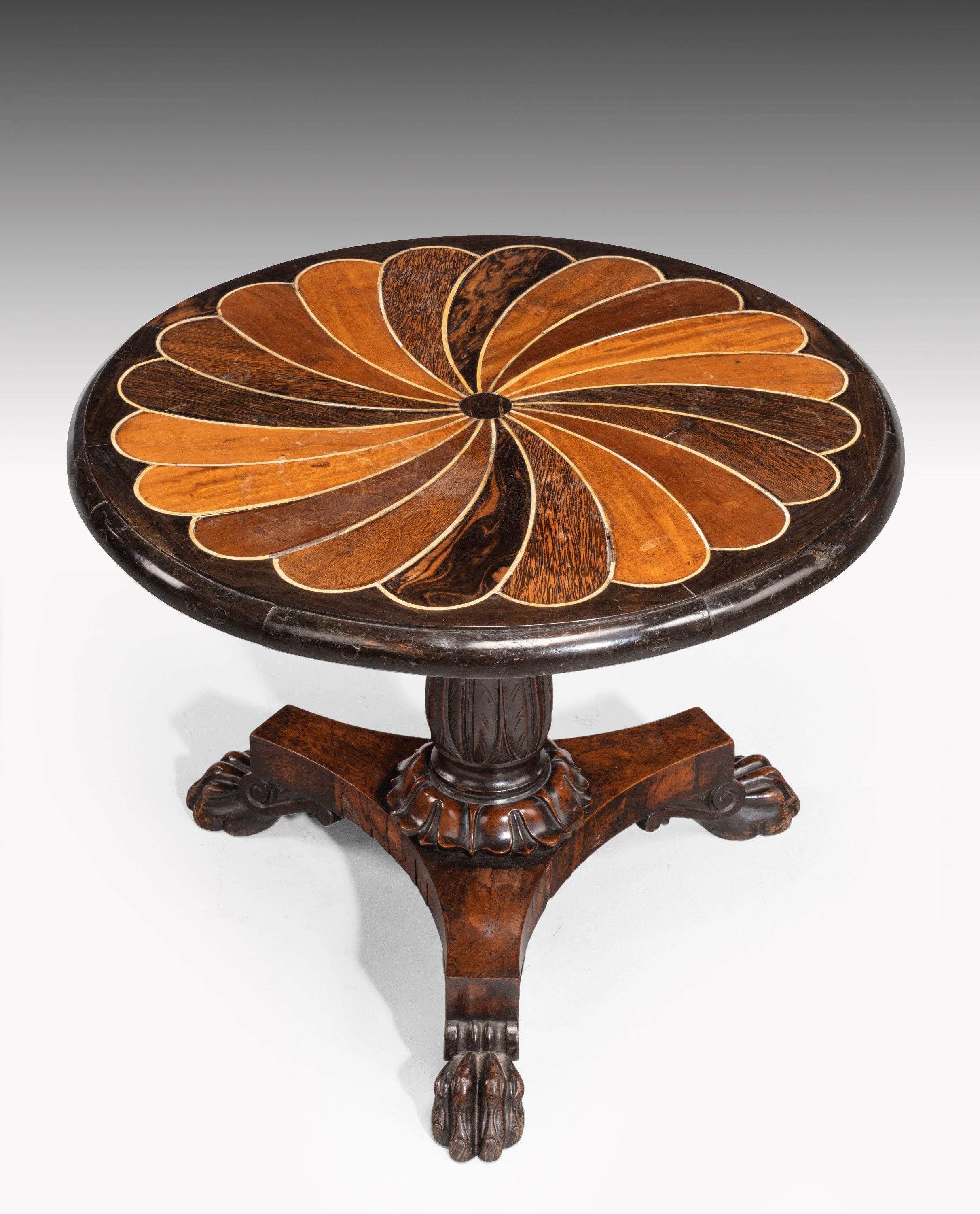 A 19th century Anglo-Portuguese inlaid table. With exotic timbers in a swirled design. Platformed base with three very well carved feet. At some point reduced in height.
 