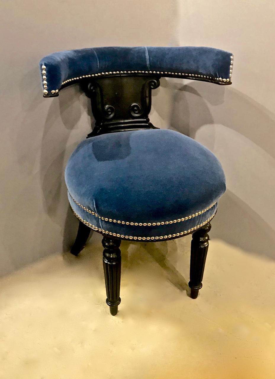 This is a very unusual late Regency period Anglo-Raj Cockfighting chair. The chair frame is crafted of ebonized hardwood, possibly rosewood, and is in very good original condition; the legs are of modified klismos form with the front legs being