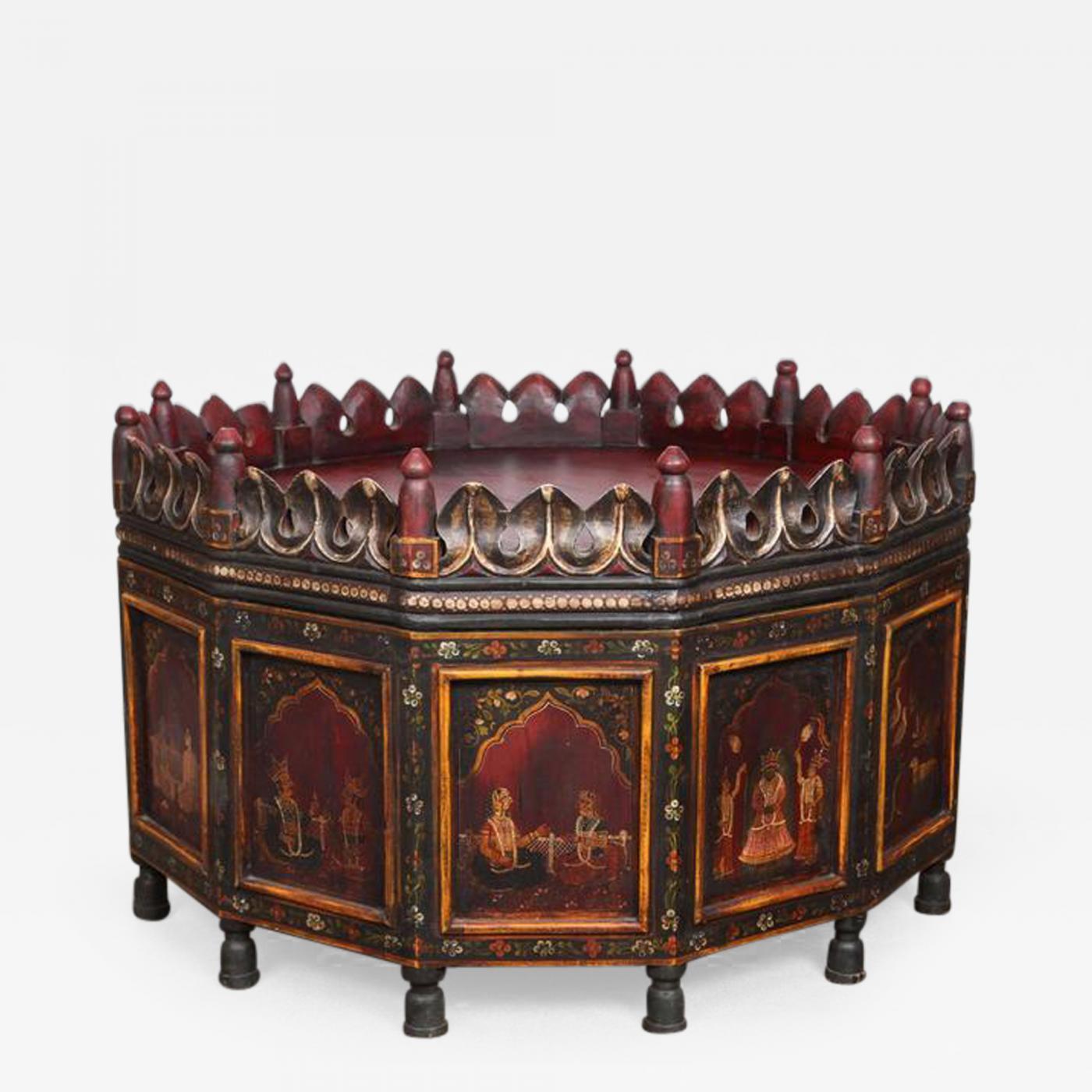 Exquisite rare Anglo Raj Indian hand-painted teak coffee table.
Top is red wine color, dark green and yellow tones.
Solid top with a leaf gallery and turned finials.
Gorgeous coffee table with decorated panels depicting stories scenes of Indian