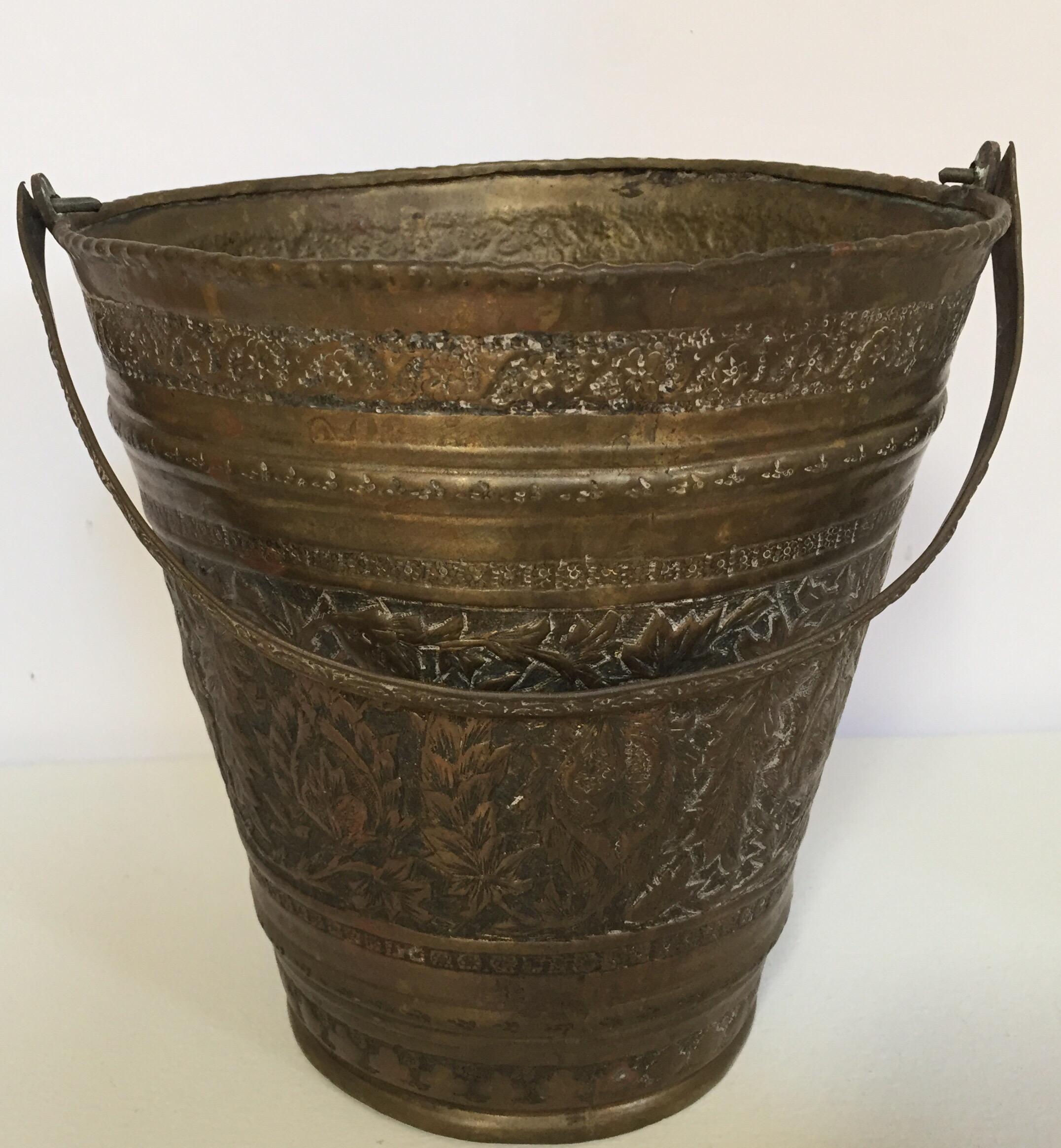 19th century Anglo Raj Mughal bronzed metal copper vessel water or milk bucket.
Originally used to carry water, this hand-hammered metal vessel from India has authentic texture, wonderful patina, and great form and character.
Great patina on