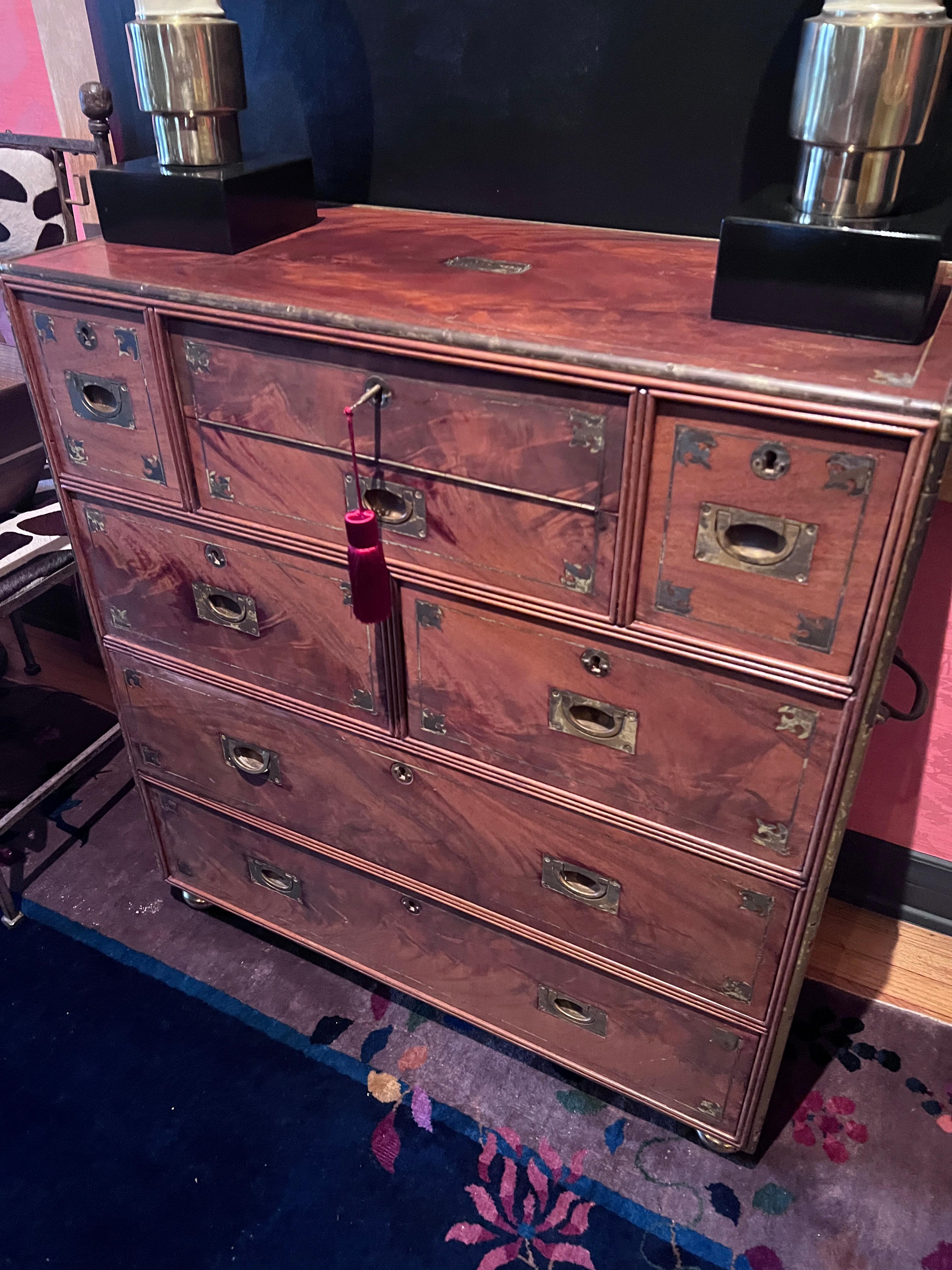 A rare Regency Campaign Chest with Desk, and six drawers for storage.  Marked, Liverpool, 1811, on Metal Label.

 The Mahogany wood is Beautifully Figured and the entire piece is banded in beautifully patinated brass.  Seven drawers are accompanied