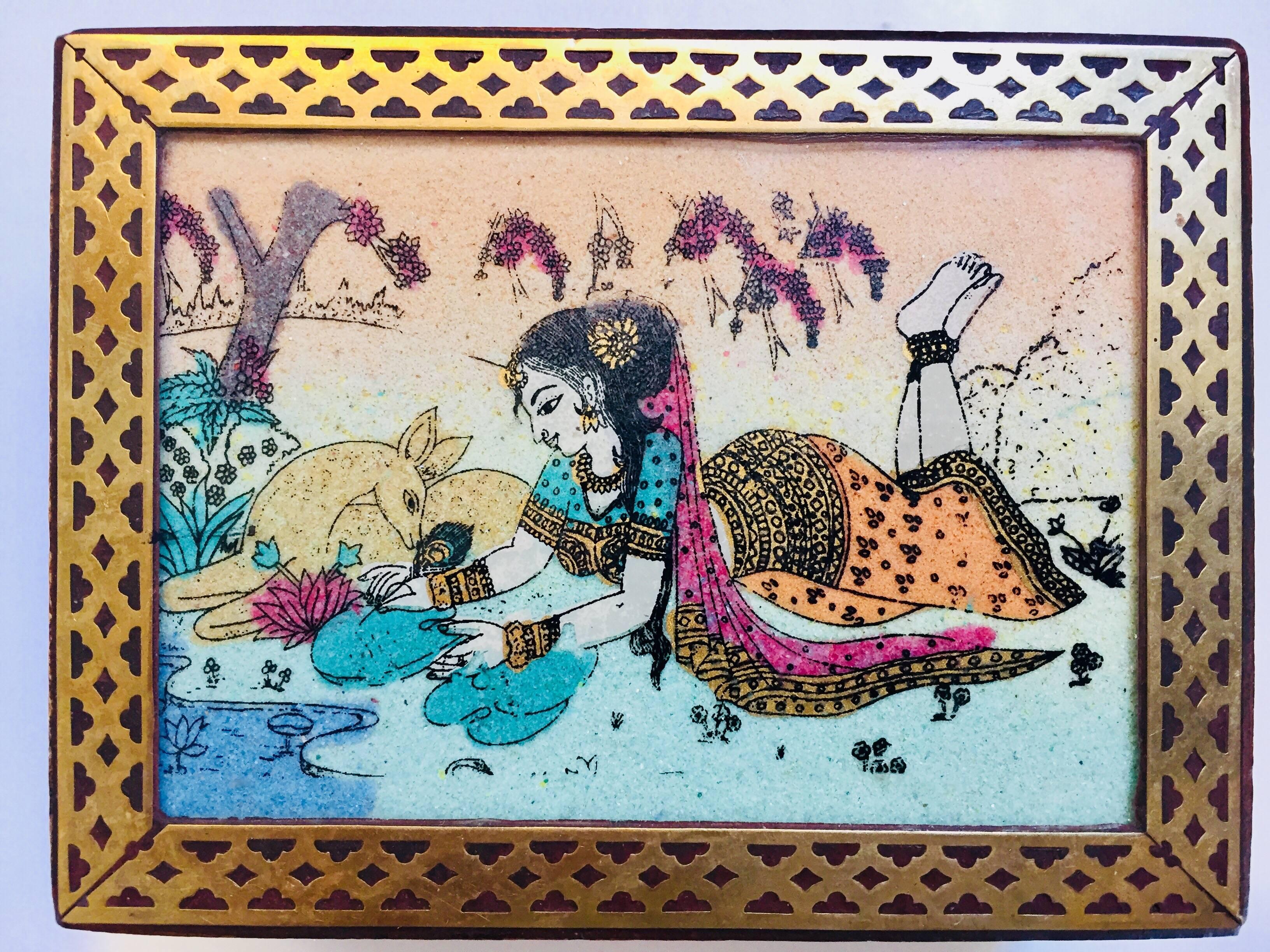 Anglo-Indian wooden box decorated with brass and hand-painted with a scene of a young lady in a forest with traditional clothes playing with a deer.
Of rectangular shape, the lid with glazed scene painted on paper, framed within engraved and