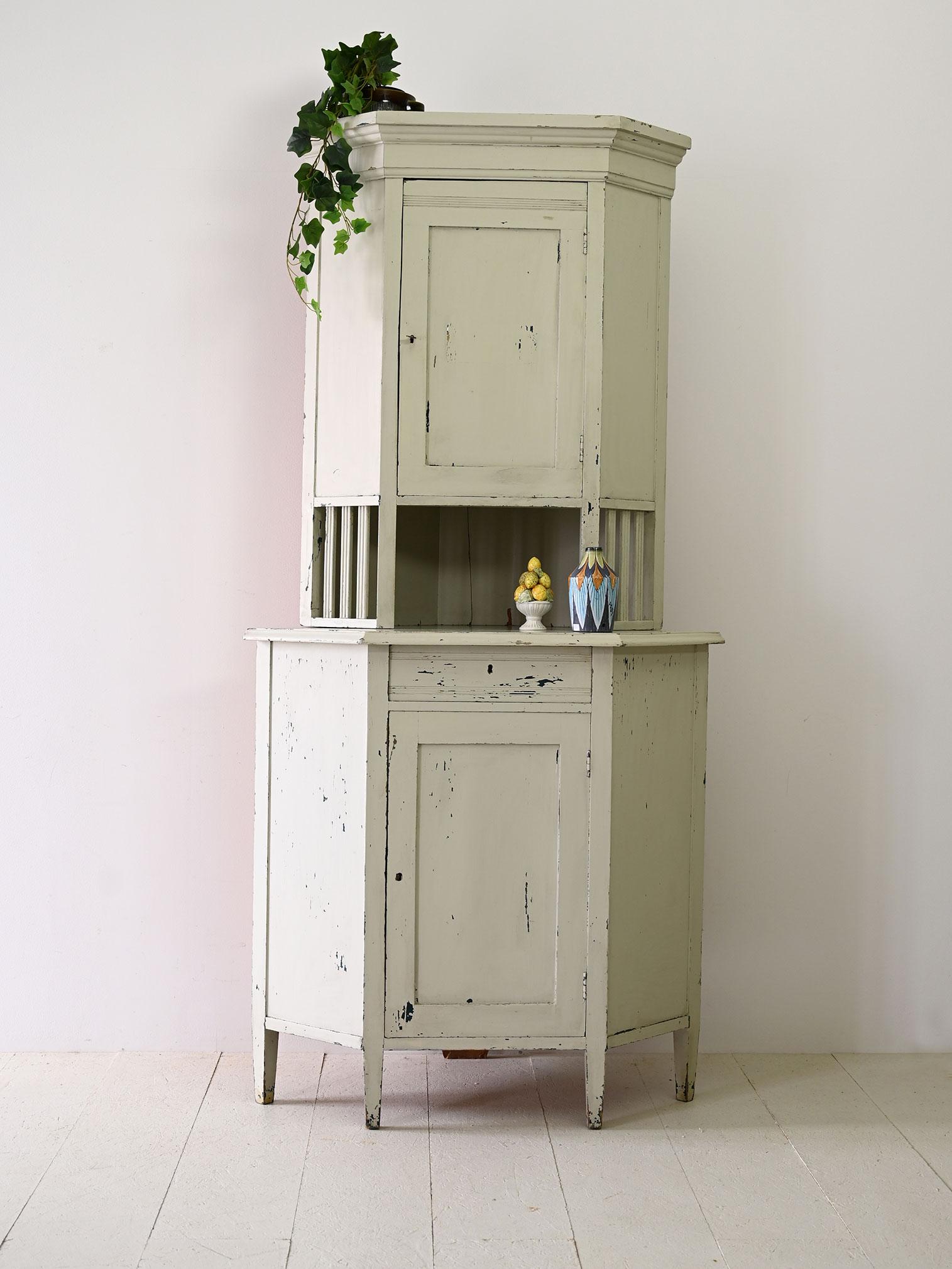 Vintage Scandinavian furniture.
 
This charming corner piece, inspired by the Nordic Scandinavian style, is made of wood painted white in the 1930s/40s.

Its structure consists of an upper and lower hinged door, both equipped with lock. In the