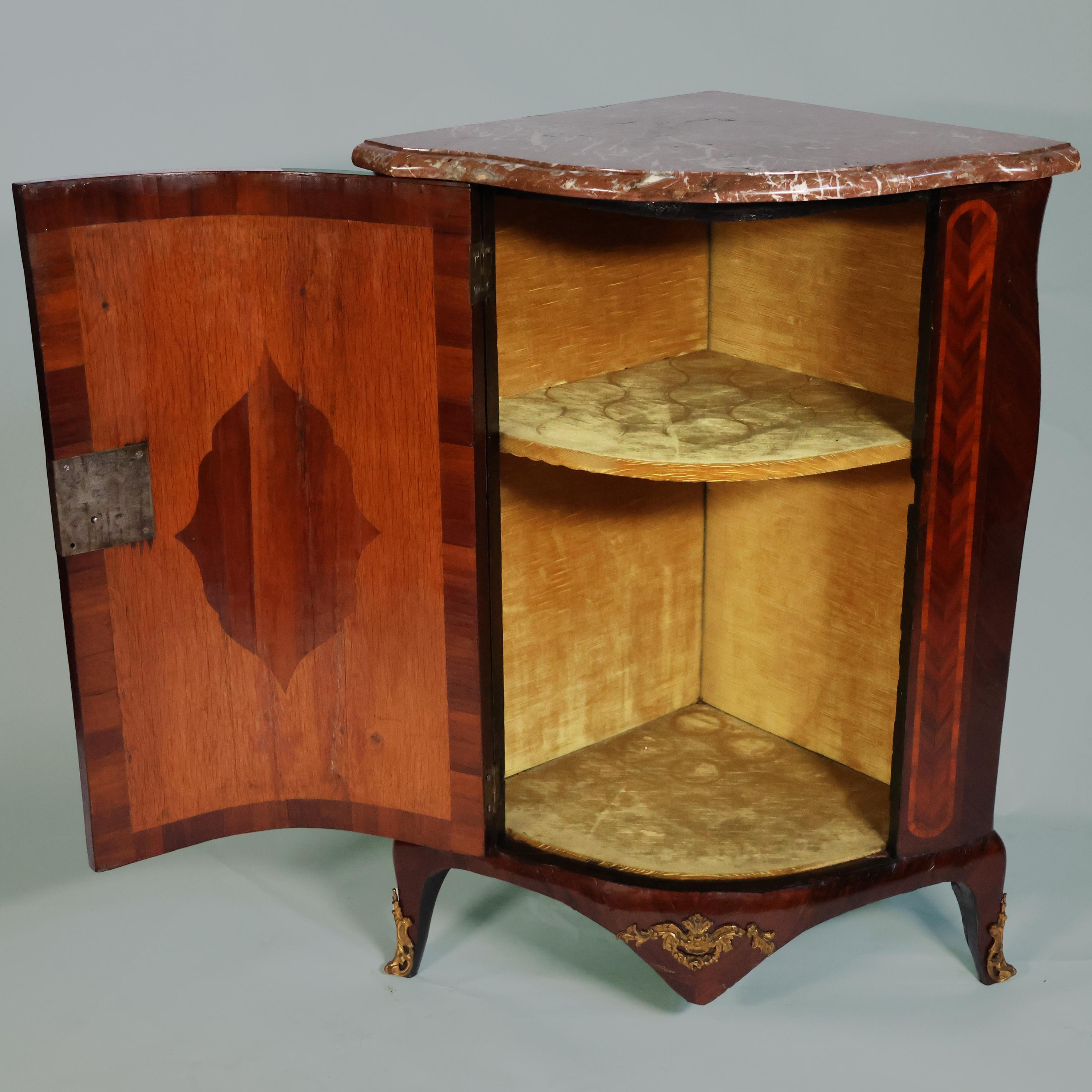 Description
Corner cabinet with rosewood, violetwood, and rosewood floral pattern inlays, Mathieu Criard, France, 18th century.
Louis XV corner cabinet of rosewood, violet wood, and rosewood, inlaid with floral motifs, gilded and chiseled bronze