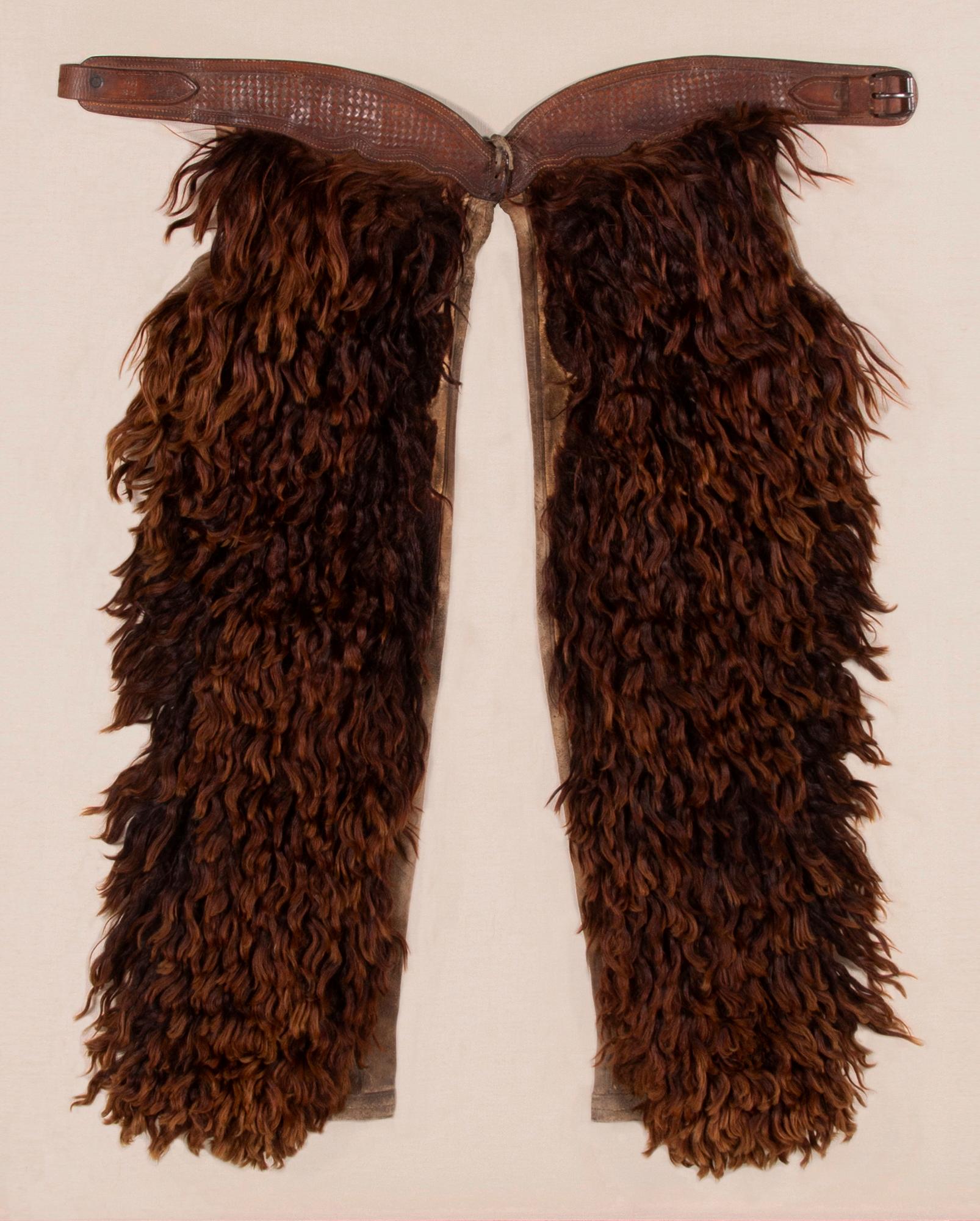 Wooly, angora chaps with beautifully tooled leather, made by the John Clark saddlery company of Portland, Oregon, signed, circa 1873-1929.

Wooly chaps made of leather and canvas, faced with dyed Angora, made by the John F. Clark Saddlery Company