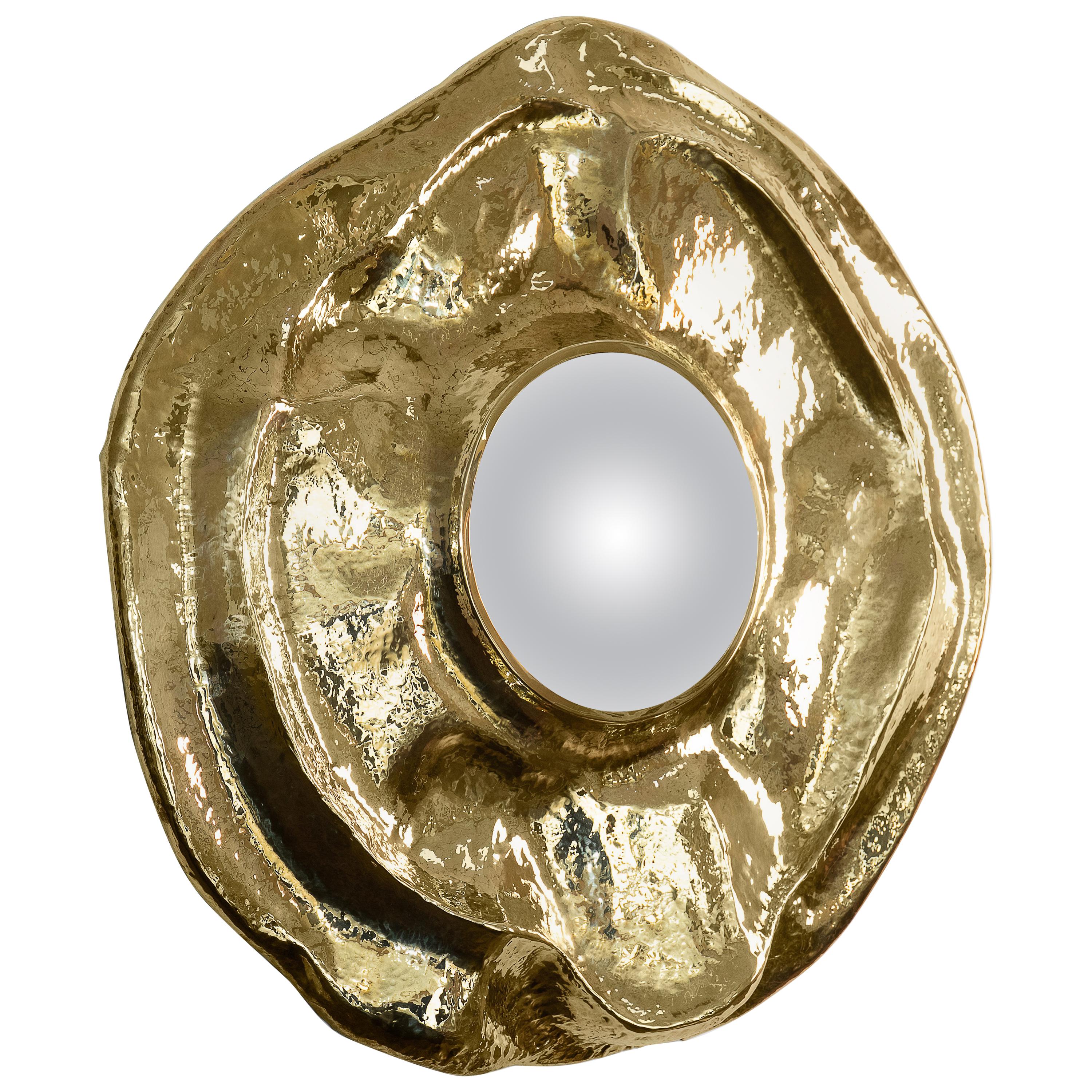 This large wall mirror offers a tribute to the historical city of Angra do Heroísmo in Azores, Portugal. The seductive and elegant mirror, it's outstanding in its shape and curved design. The polished brass creates a superb accent providing a