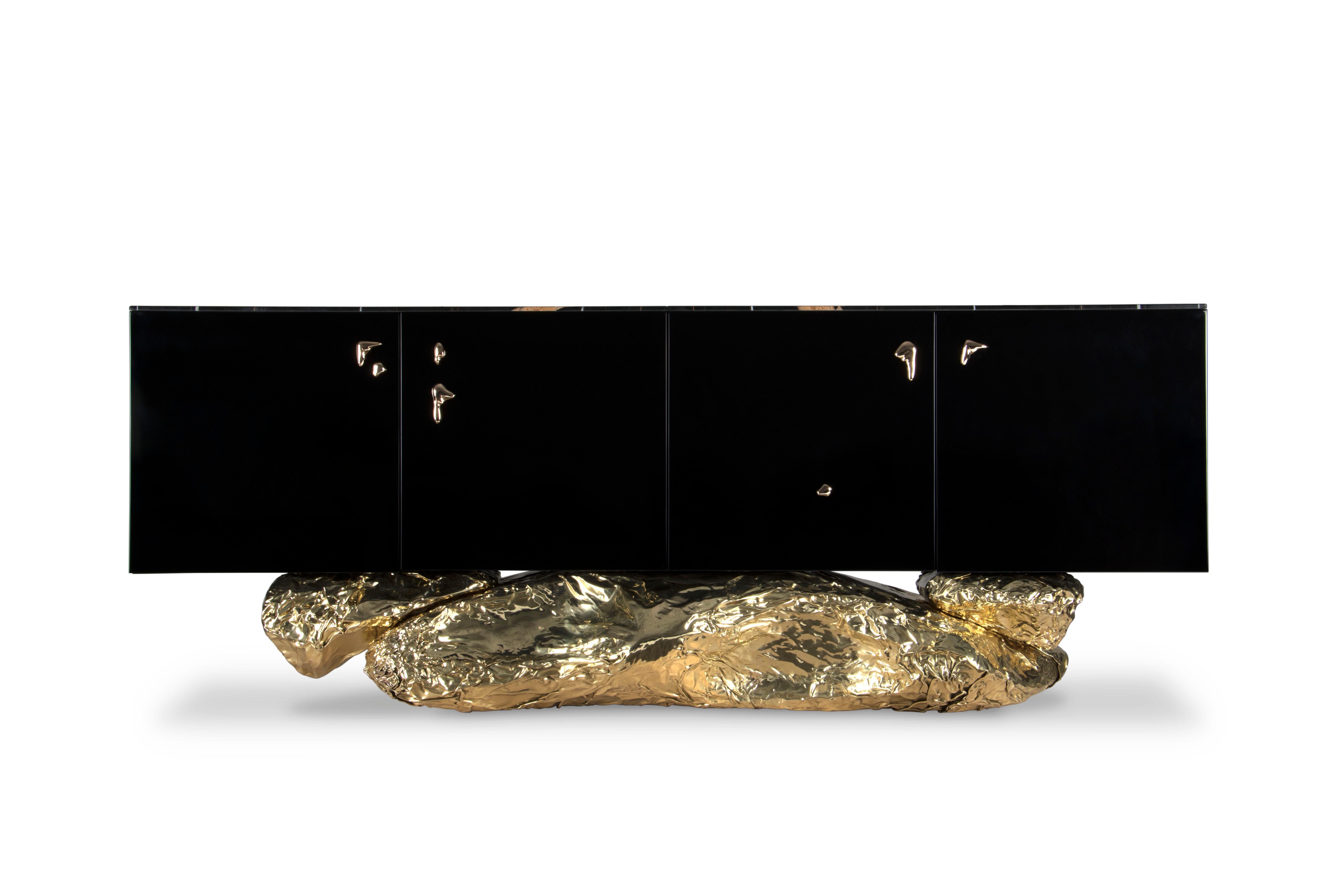Modern Contemporary Angra Black with Brass Base Sideboard by Boca do Lobo

Modern Contemporary Angra Black with Brass Base Sideboard is a black and gold sideboard, with a sharped body fully covered in black high gloss,  and it gently lies in an