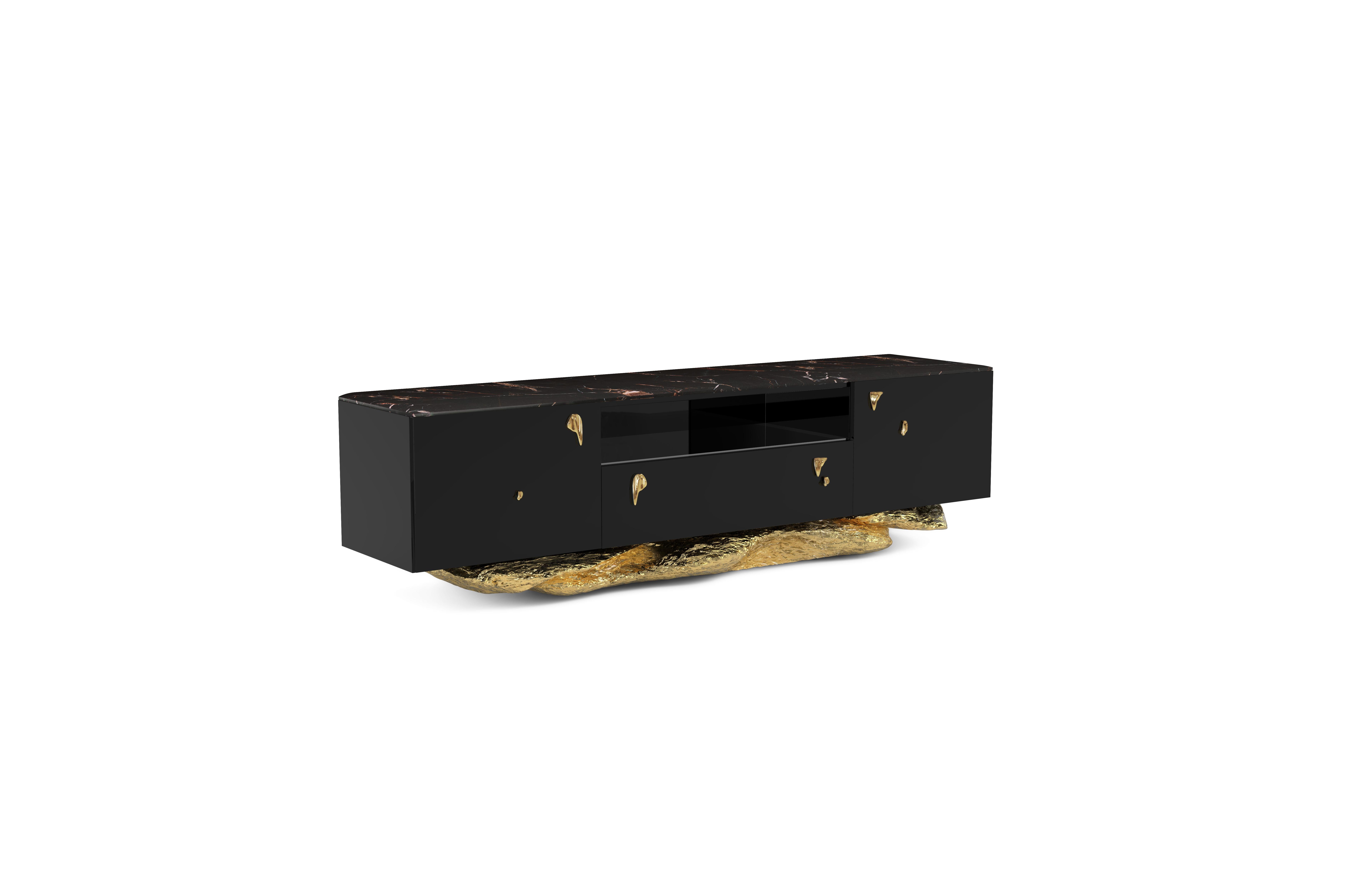 The Angra TV Cabinet is a fusion of art and functionality. This cabinet stands elegantly on a distinctive curved golden base, drawing inspiration from the captivating cliffs of Angra do Heroismo in Portugal's Azores. As you enjoy this masterpiece,