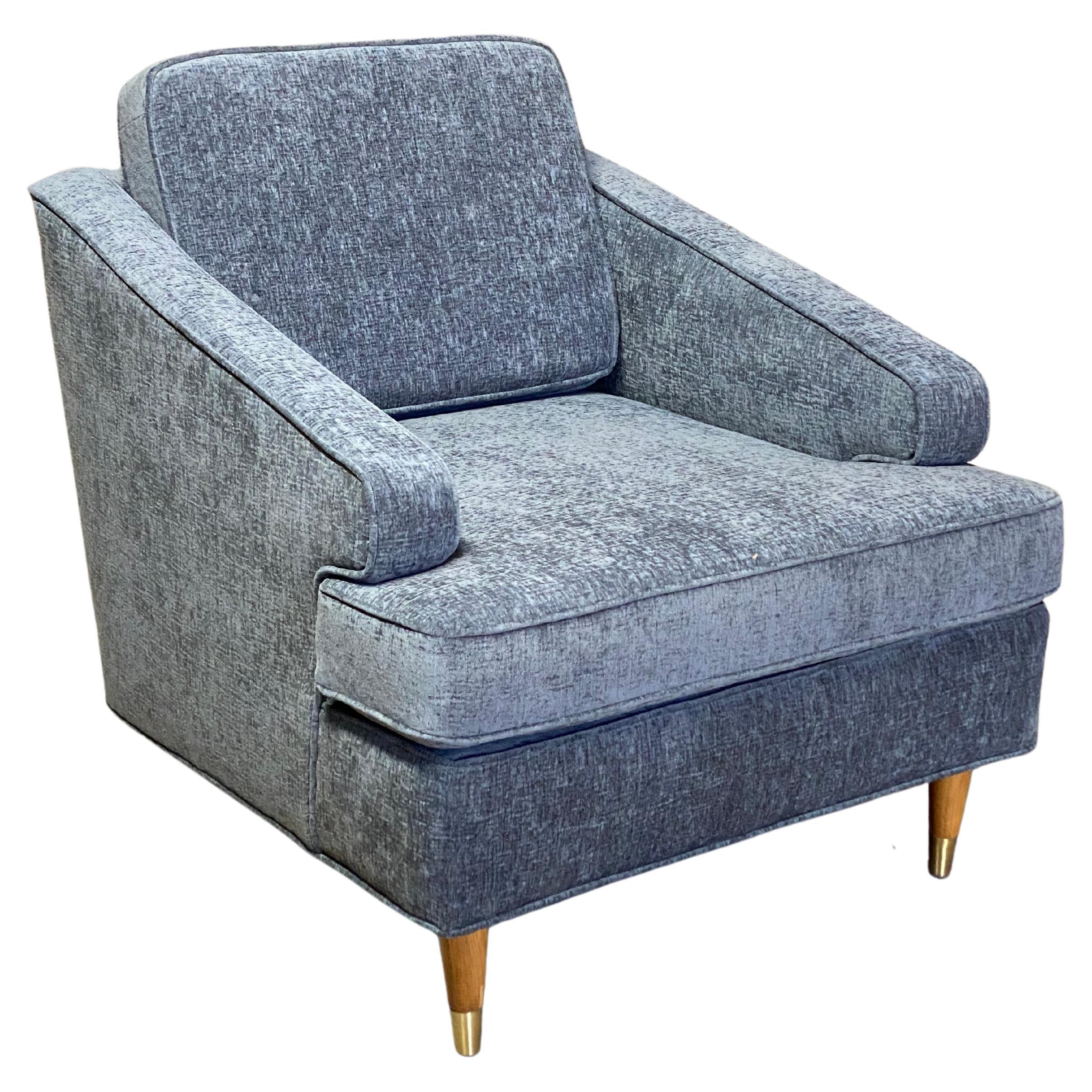 A very sexy chair! Compact and angular, but due to the lines and subtle curves it gives the appearance of a much larger chair. A chair with, most importantly, presence and comfort. Newly upholstered in light gray Nanolux crushed velvet fabric and