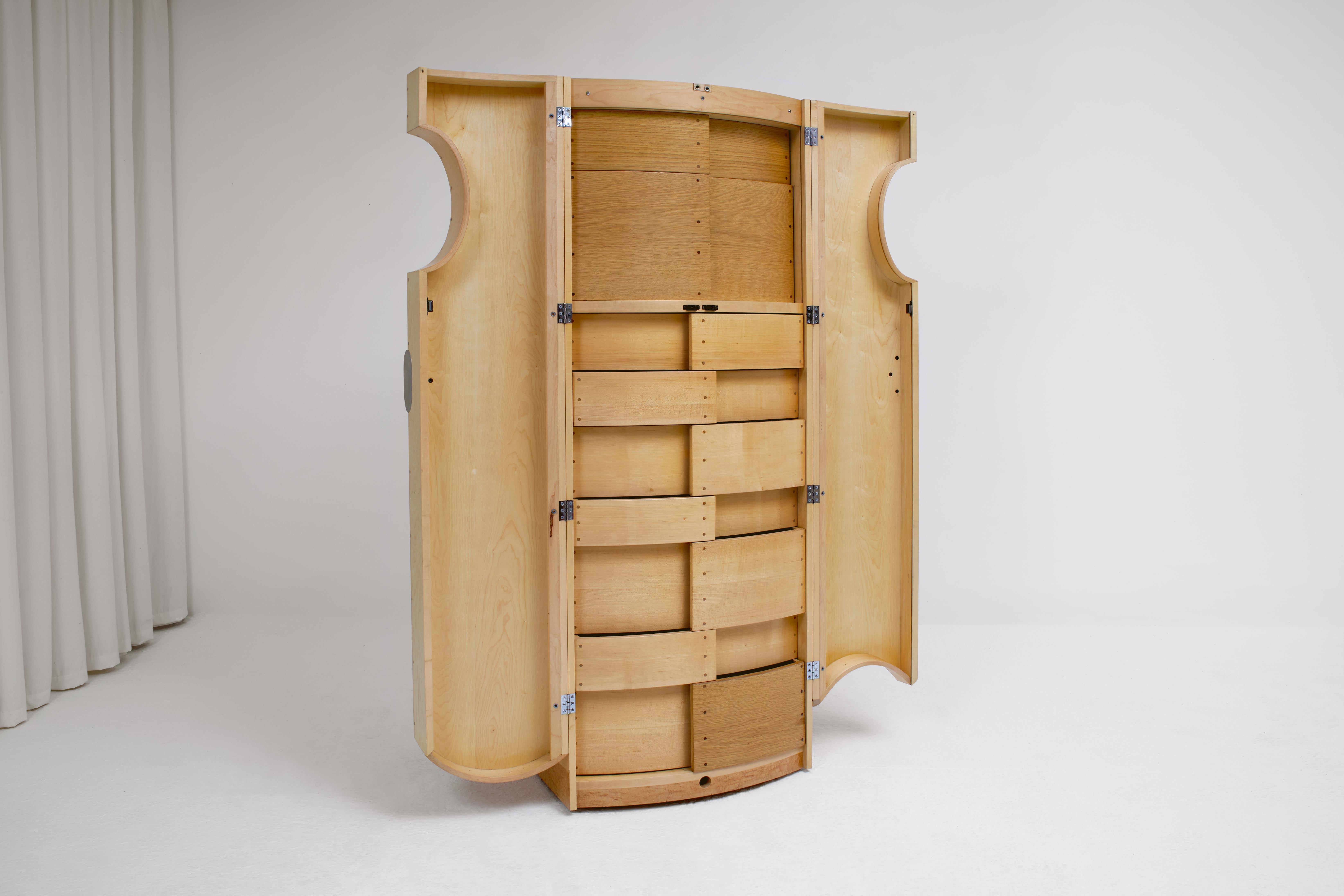 This cabinet was designed and produced by Scottish based craftsman Angus Ross in 2000. He was commissioned by The Wilson Art Gallery and Museum to build a museum quality cabinet to display their costume and textile collection. The cabinet has since