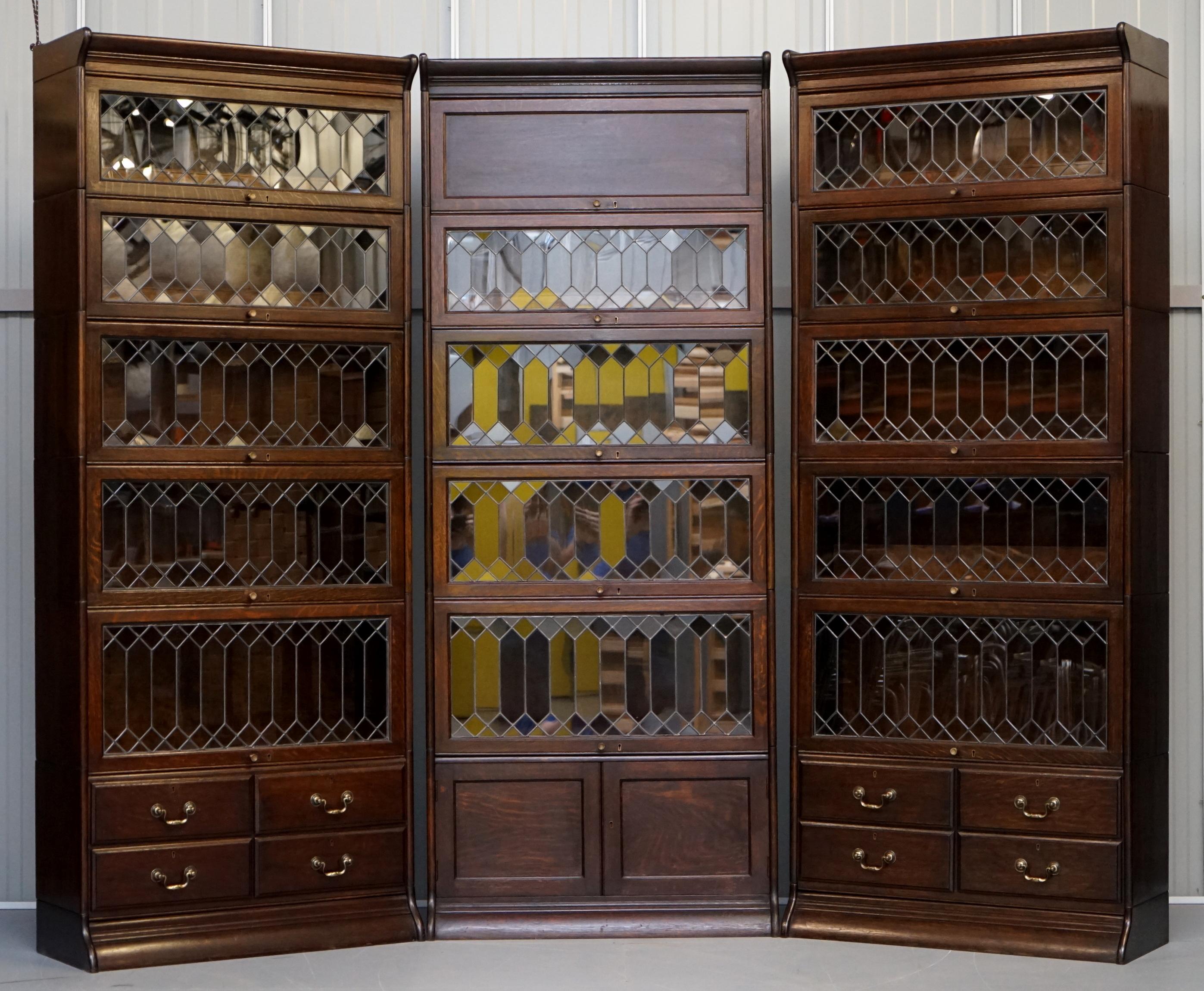We are delighted to this very rare circa 1910 suite of three Legal stacking bookcases with lead lined glass made by Gunn in solid oak and with all original solid brass Angus of Scotland & England locks 

This is an exceptionally rare find, firstly