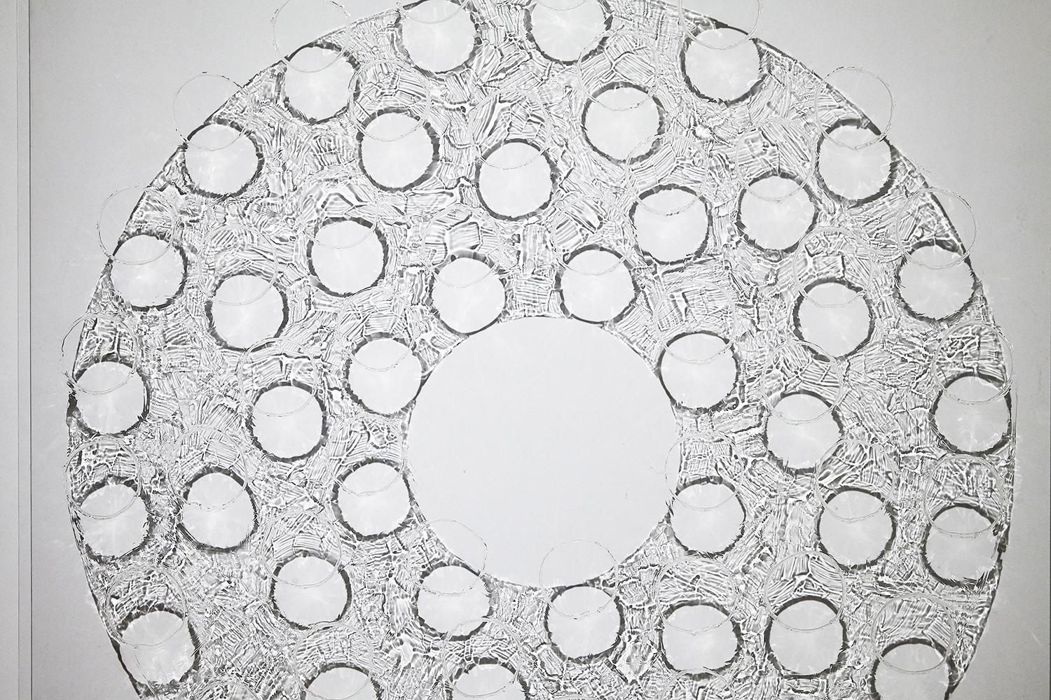 Shadows cast by light shone through translucent gel patterns on clear plexiglass create an elegant non-material extension of the image. This unique painting is wall mounted and hangs about four inches from the wall. Aluminum clips are used to