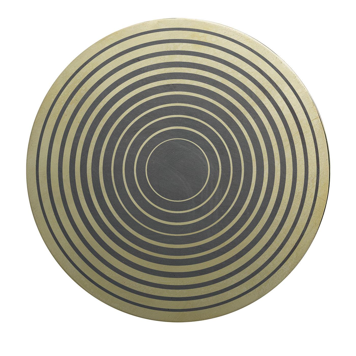 Fashioned of brass and decorated using oxides, this decorative disk will enliven a contemporary or mid-century modern interior. The tenets of Aniconism banning the visual depiction of living and supernatural creatures shared by many cultures