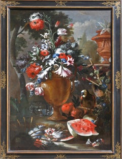 A still life of flowers in an urn with a parrot, melon, pomegranates and figs...
