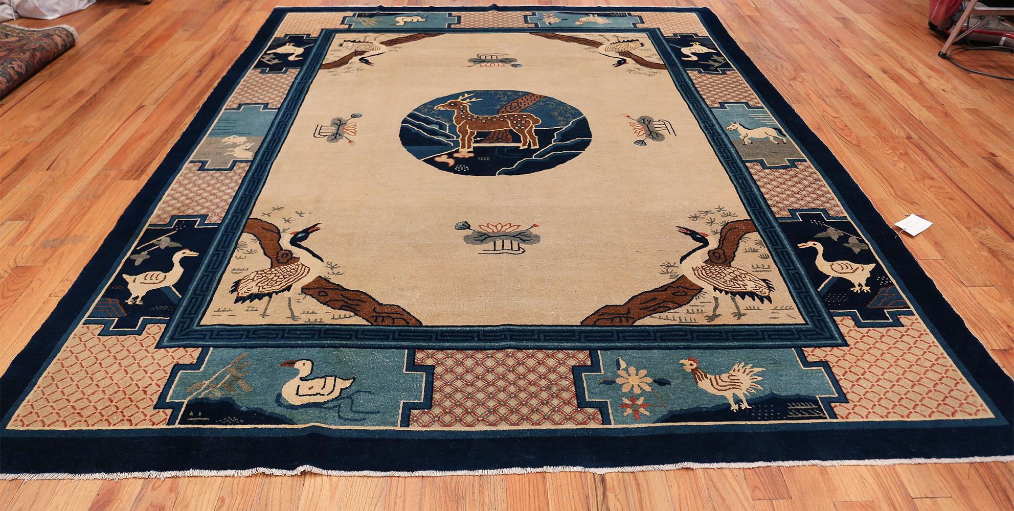 Magnificently Calm Antique Animal Motif Chinese Rug , Country of Origin / Rug Type: China, Circa Date: 1920. Size: 8 ft x 9 ft 8 in (2.44 m x 2.95 m)

This beautiful antique Chinese rug features a lovely animal motif set against a predominately