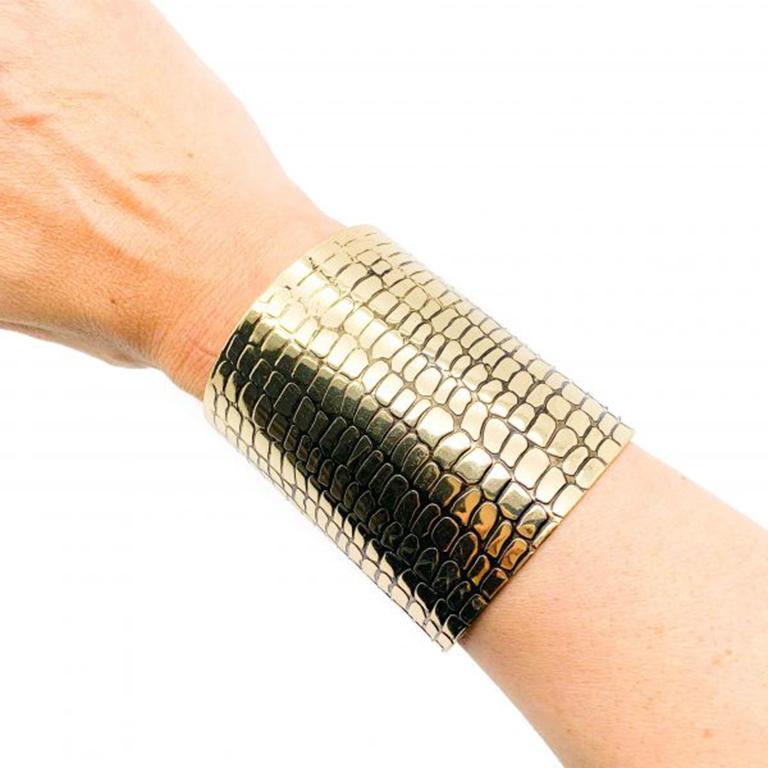 Make a style statement with this Animal Print Amulet Cuff. Featuring gold tone metal imprinted with a snakeskin effect. In very good condition, measuring approx. 6.2cm inner diameter and approx. 7.5cm long. The amulet can be worn on the skin or over