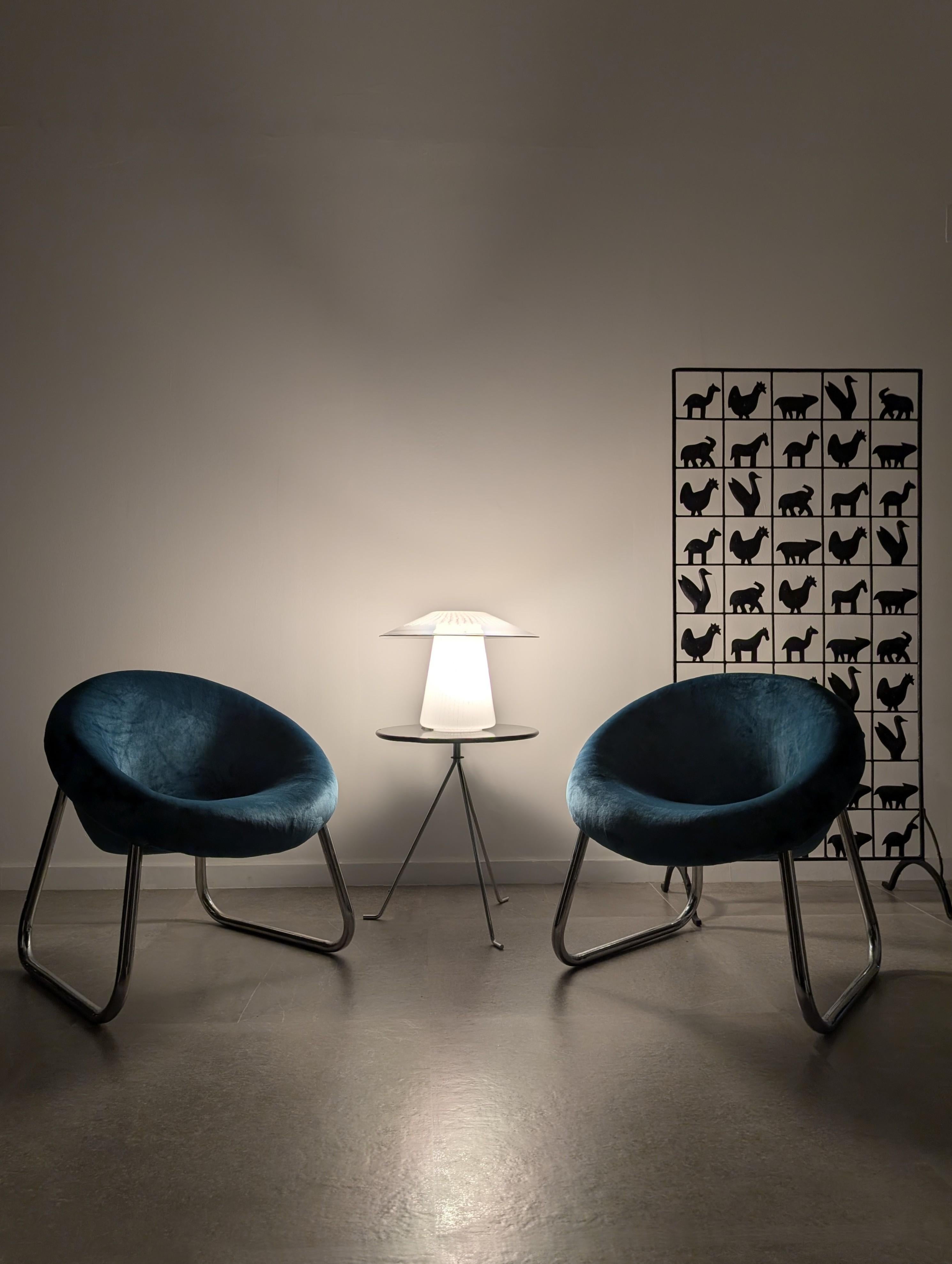 French wrought iron screen by Atelier Marolles under the direction of renowned designer and sculptor Jean Touret. This beautiful room divider is composed of a carefully hand-crafted grid that frames a series of stylized animal silhouettes, standing