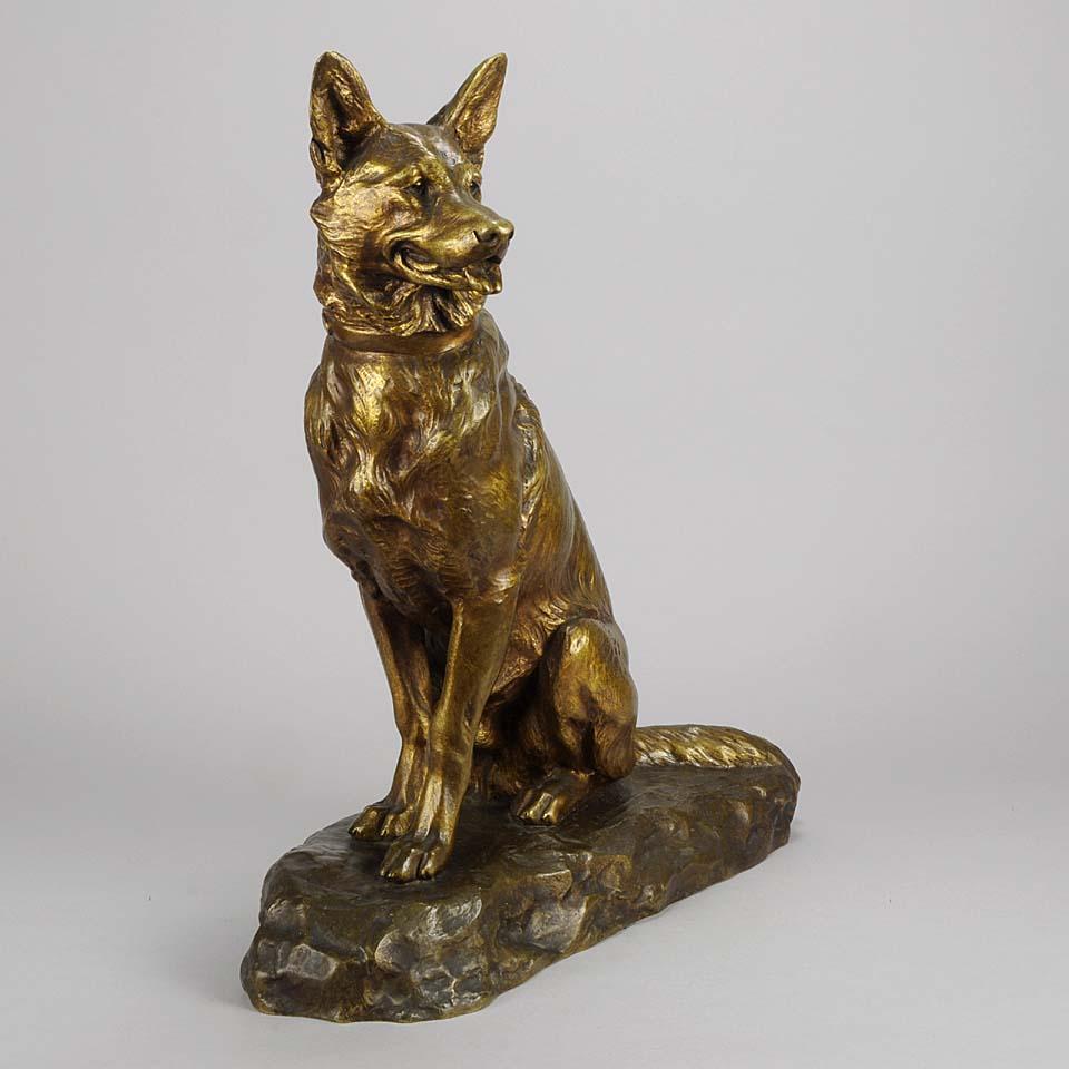 A striking French Animalier gilt bronze study of a seated Alsatian in alert pose with head turned slightly and ears pricked. The surface with excellent naturalistic detail and very fine color, signed L.Riché.
    