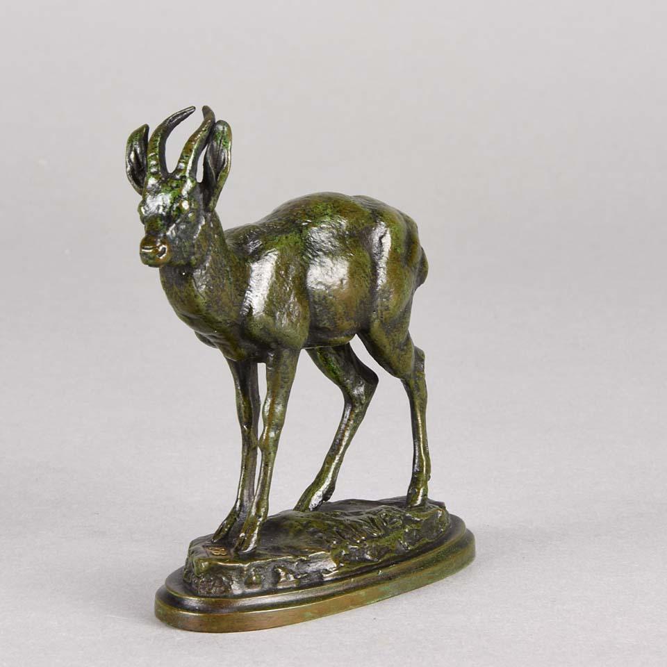An exquisite French animalier bronze figure of a Kevel Antelope, the bronze with mid brown, orange and olive green ‘autumnal’ patination exhibiting excellent detail and finish, signed Barye on oval base, inscribed F Barbedienne and inset with gold