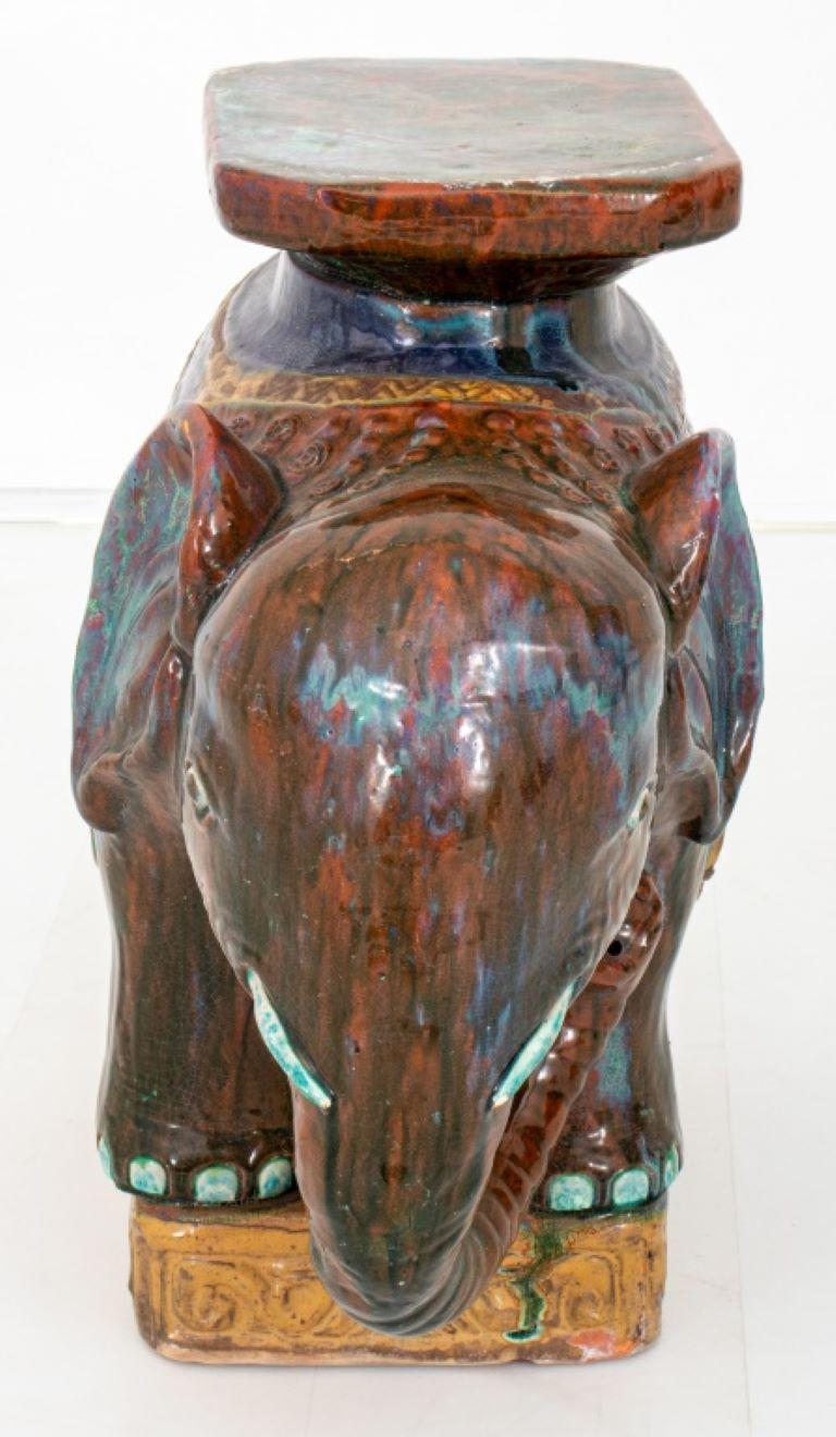 Polychrome glazed ceramic sculpture of an elephant forming a plant stand or stool / side table.

Dealer: S138XX