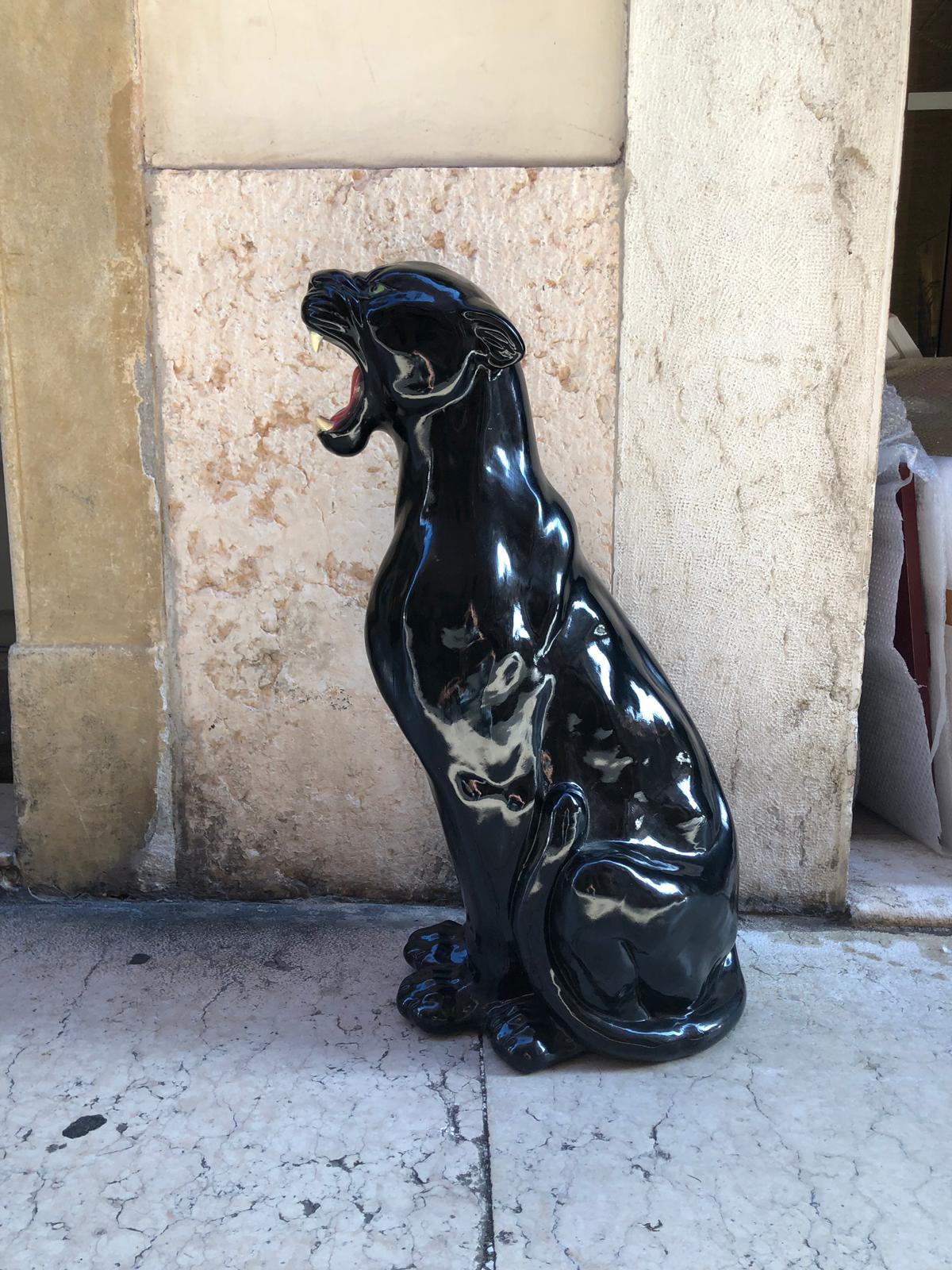 Black shiny ceramic seating and roaring Panther from Italy from 1980s. The inner part of the mouth is red and teeth are white to emphasize the roar. Tail is wrapped around the body. Dimensions: H 88 cm / 35