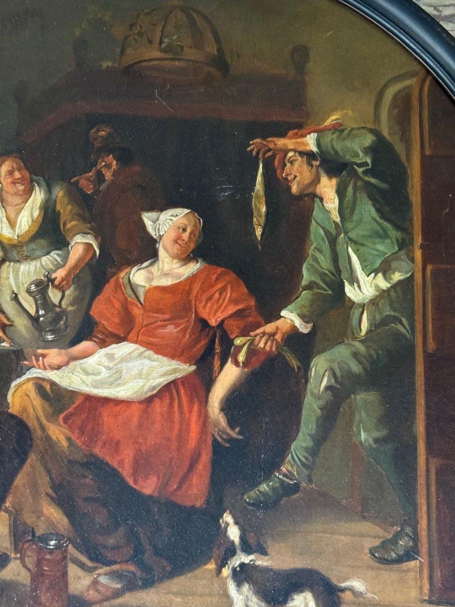 Scène animée dans une taverne, huile sur toile, carton de protection au dos. Signature en bas à droite
