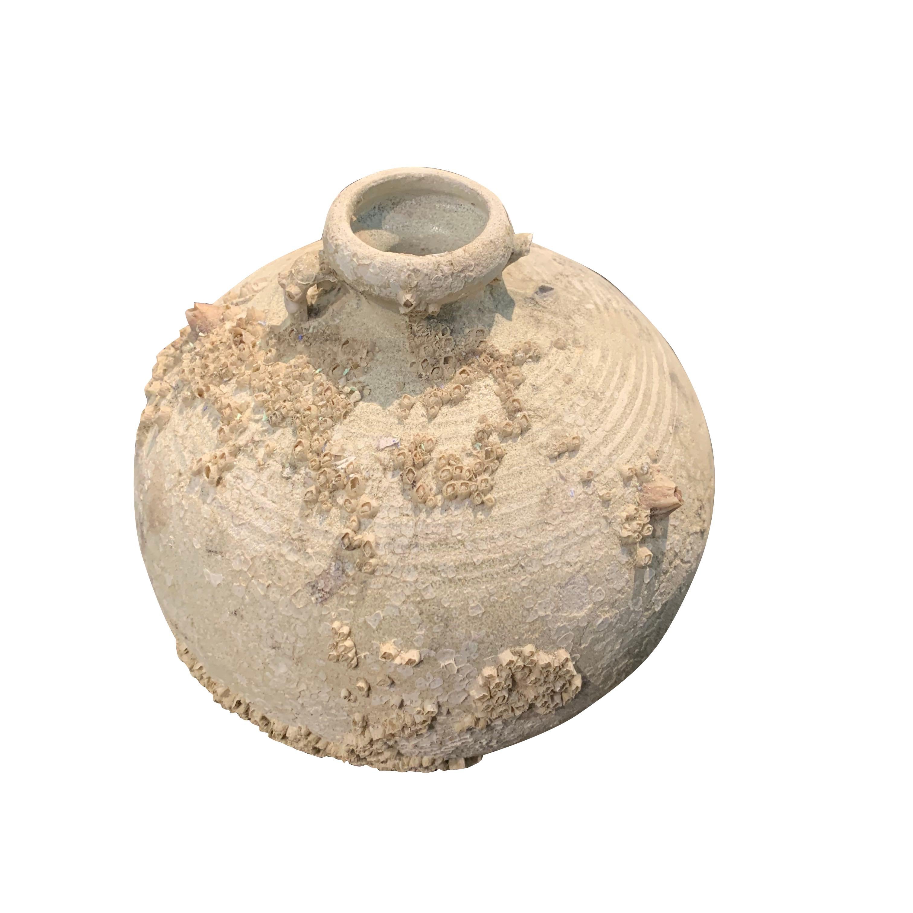 15th century Vietnamese animist neutral terracotta pot.
Animism is the belief that all objects have a spirit.
Shipwrecked, weathered and covered with barnacles which offer an organic dimension to the design of the pot.
Two pots are available.  Both