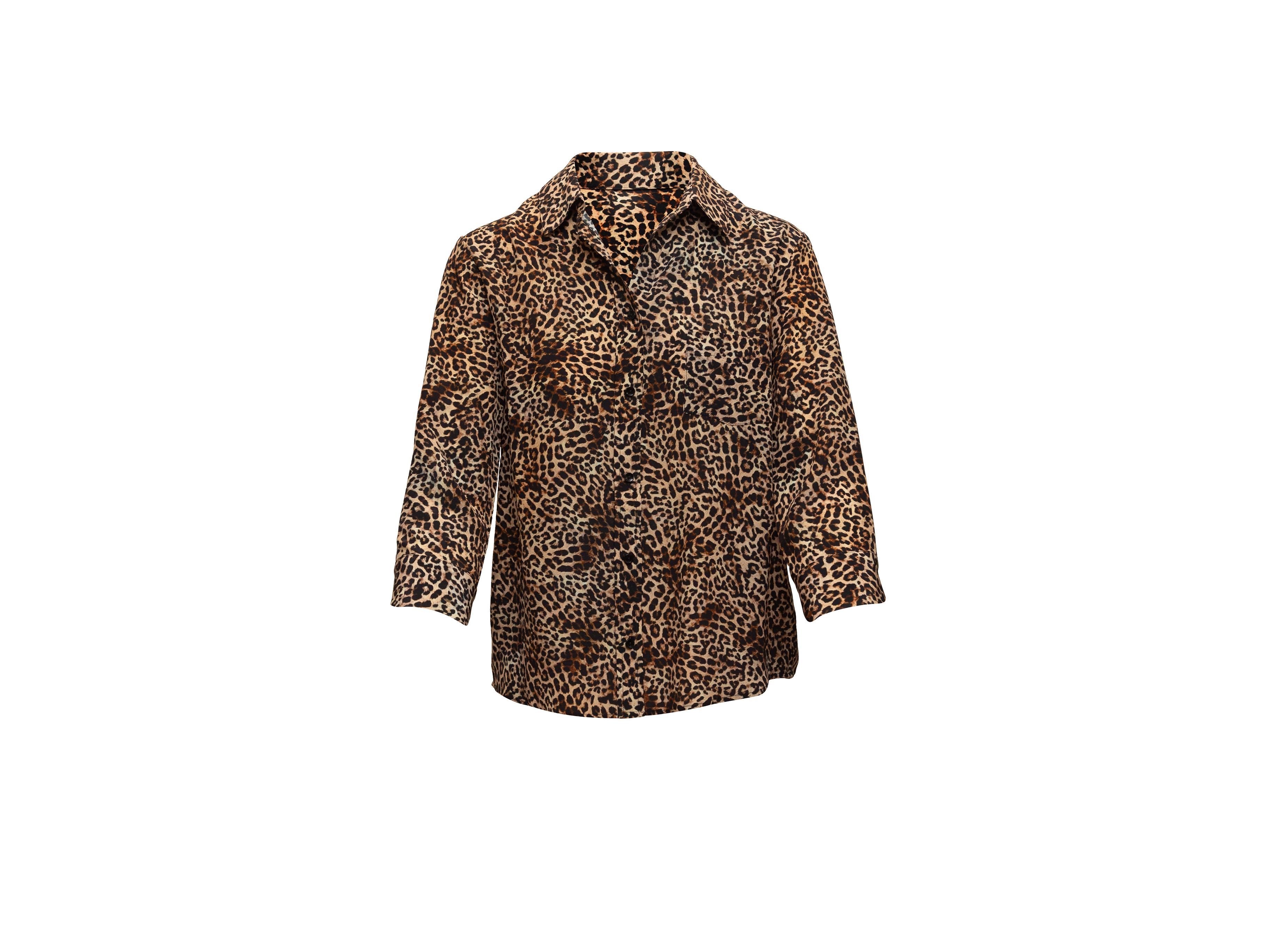 Product details: Tan and black silk leopard print top by Anine Bing. Pointed collar. Three-quarter sleeves. Button closures at center front. 40