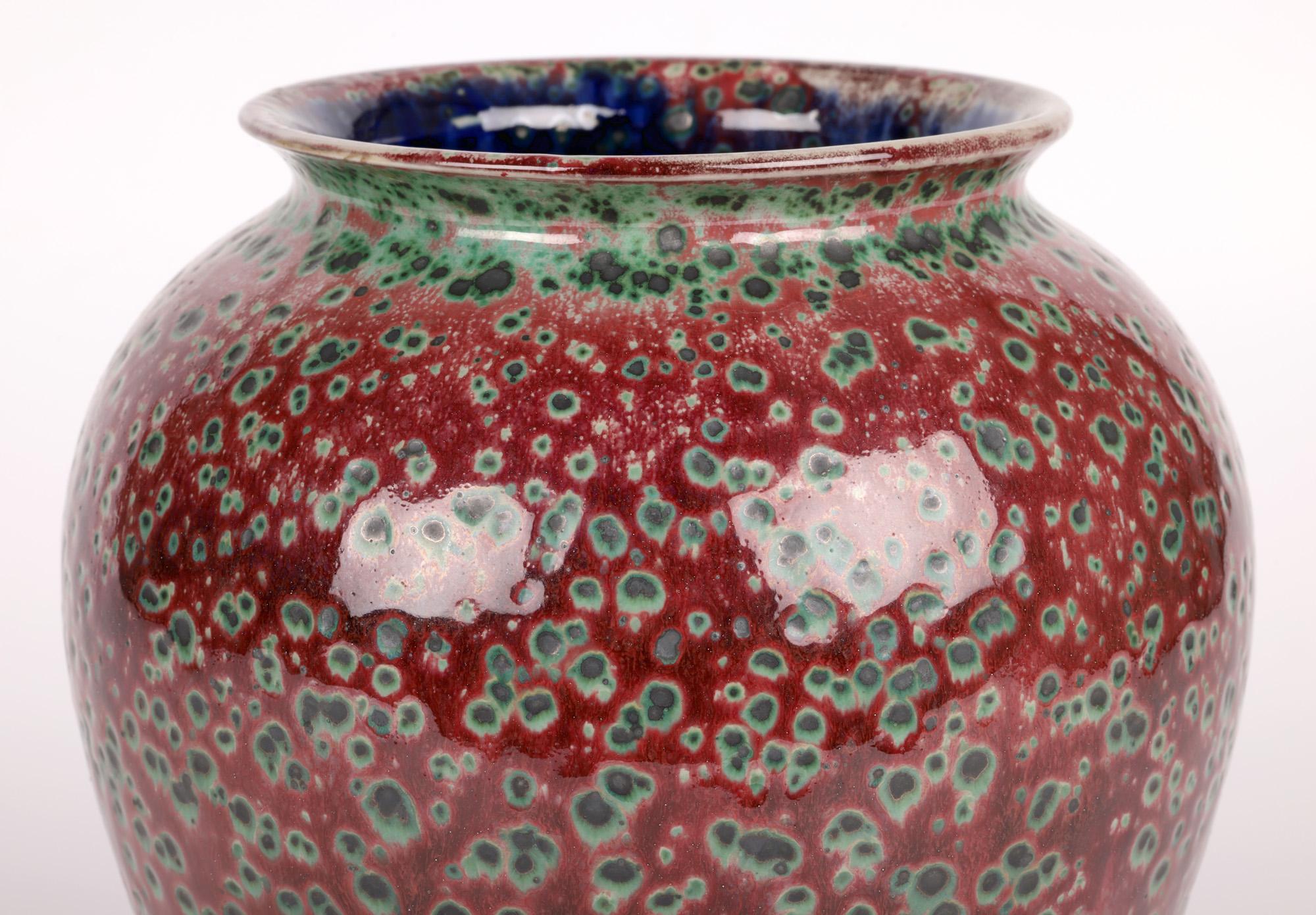 An exceptional, impressive unique Cobridge pottery ruskin glazed vase by Anita Harris and glazed by Justin Emery and dating from around 2000. The large round bulbous stoneware vase stands on a round skirted base with a widening round body and short