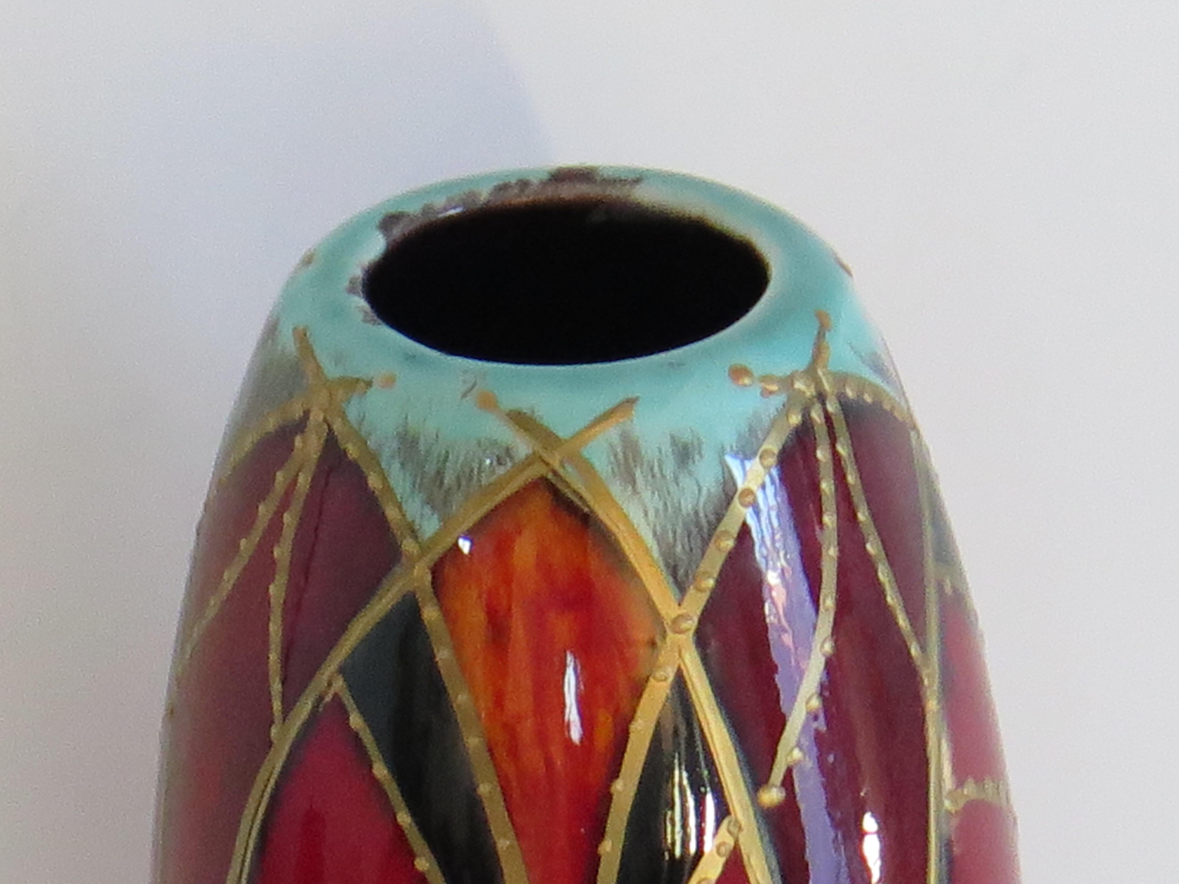 This is a beautiful hand made and hand painted Vase by renowned designer Anita Harris of Stoke on Trent, England, dating to circa 2010.

The vase is very well potted in a cylindrical form.

The vase is richly hand decorated with lustrous (flambe)