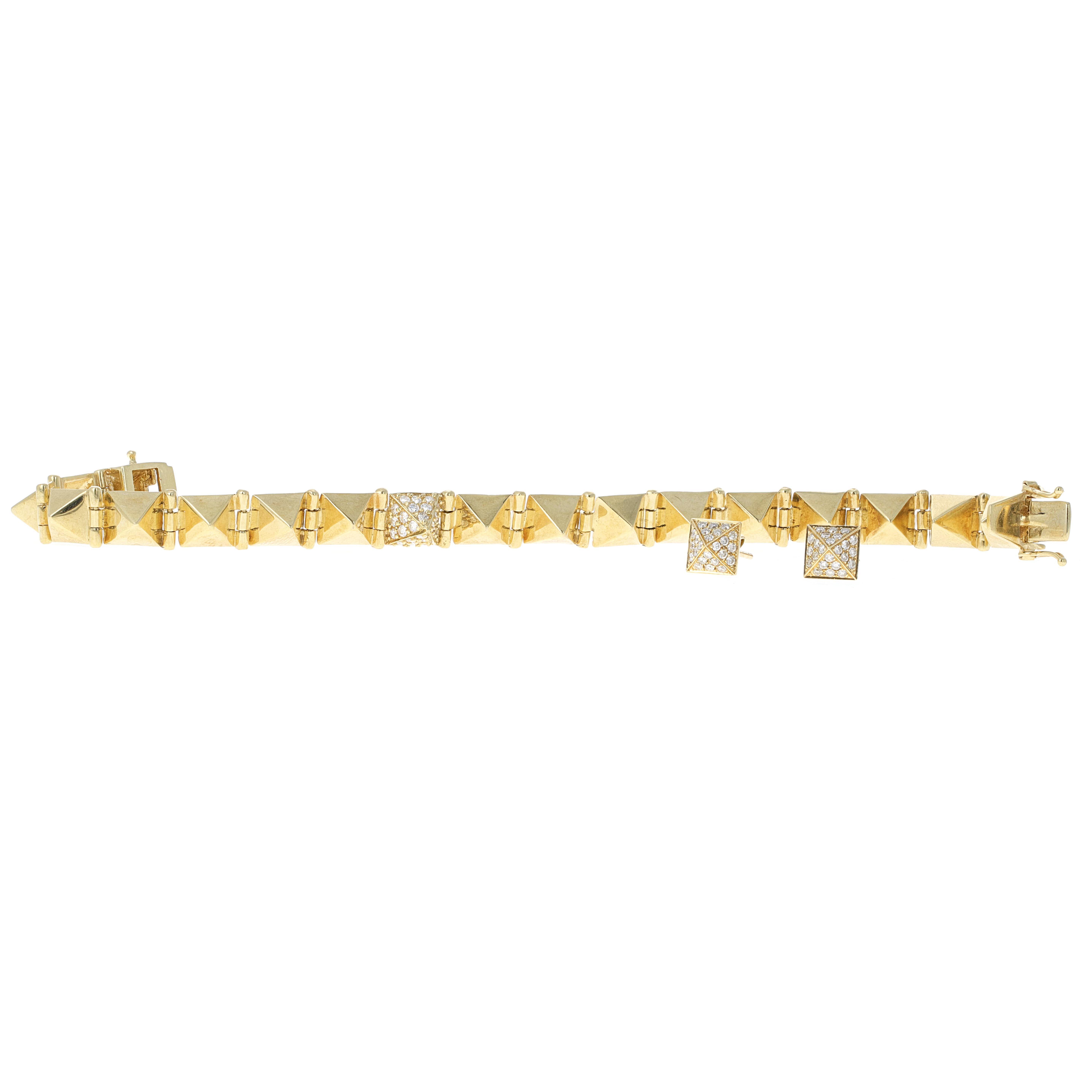 Authentic Anita Ko 18 karat yellow gold spike diamond bracelet and earrings set. The yellow gold spike bracelet has a center spike with micro pave white round diamonds. The earrings are spike studs that match the center link on the bracelet. They