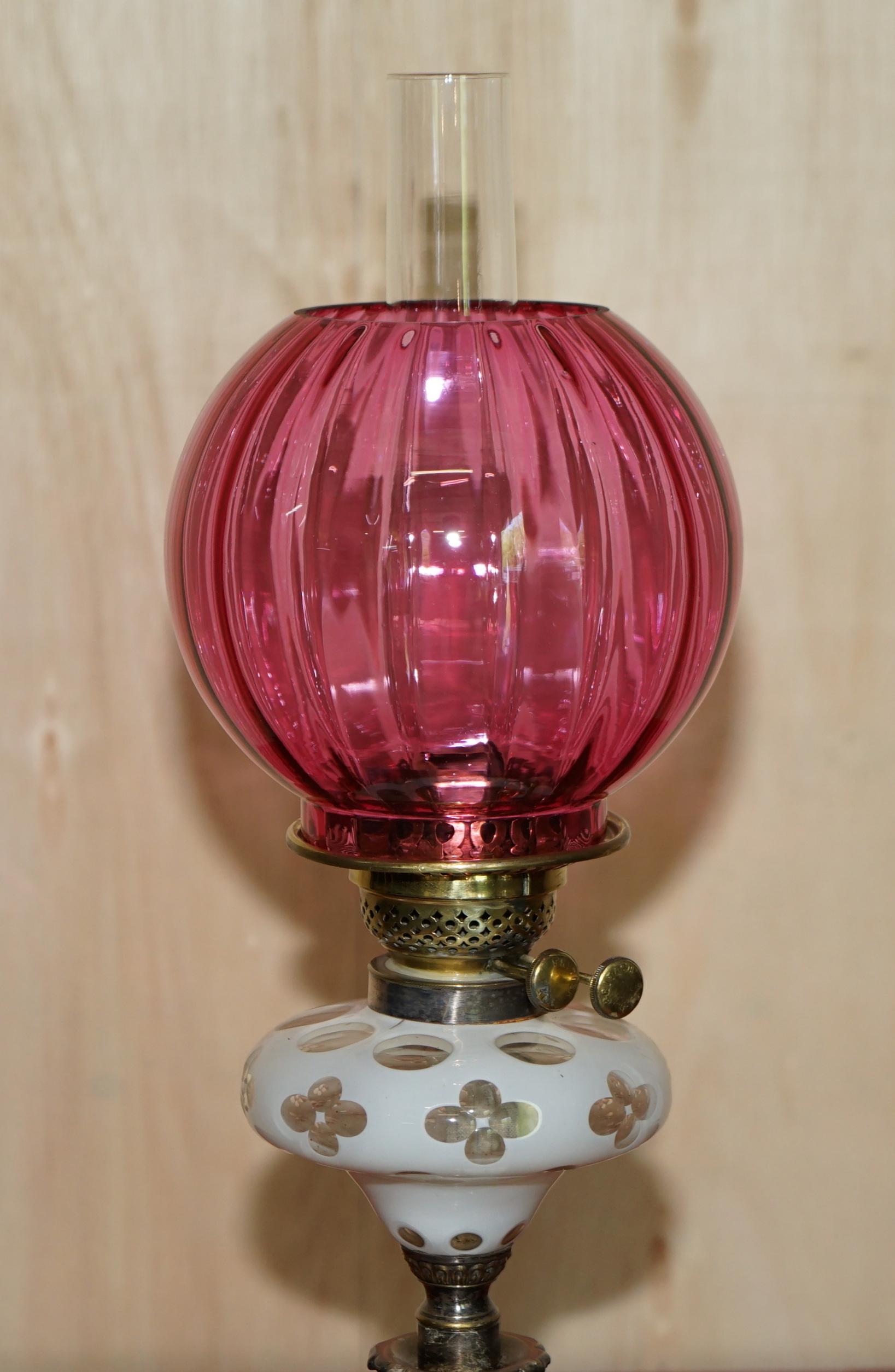 We are delighted to offer for sale this stunning Victorian, repousse brass base oil lamp with etched glass floral body and Ruby glass shade

I have a suite of seven Victorian oil lamps

The lamp has a rare repousse base with etched glass oil