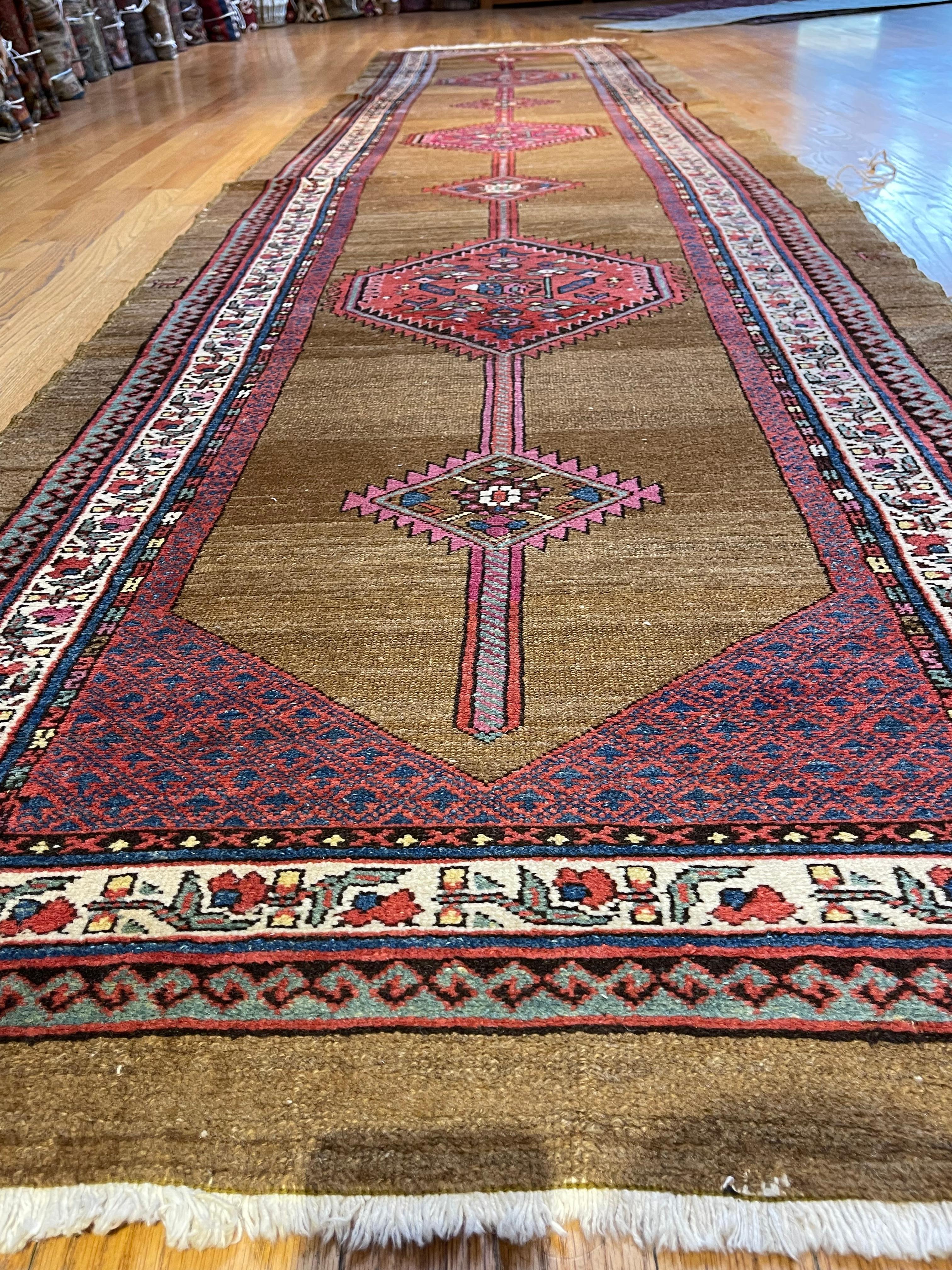 This runner was hand woven in the village of Serab, north west Persia. Hand spun camel wool, both natural and synthetic dye was used to make the runner. Village of Serab is known to make runners and not room size carpet, presumably because