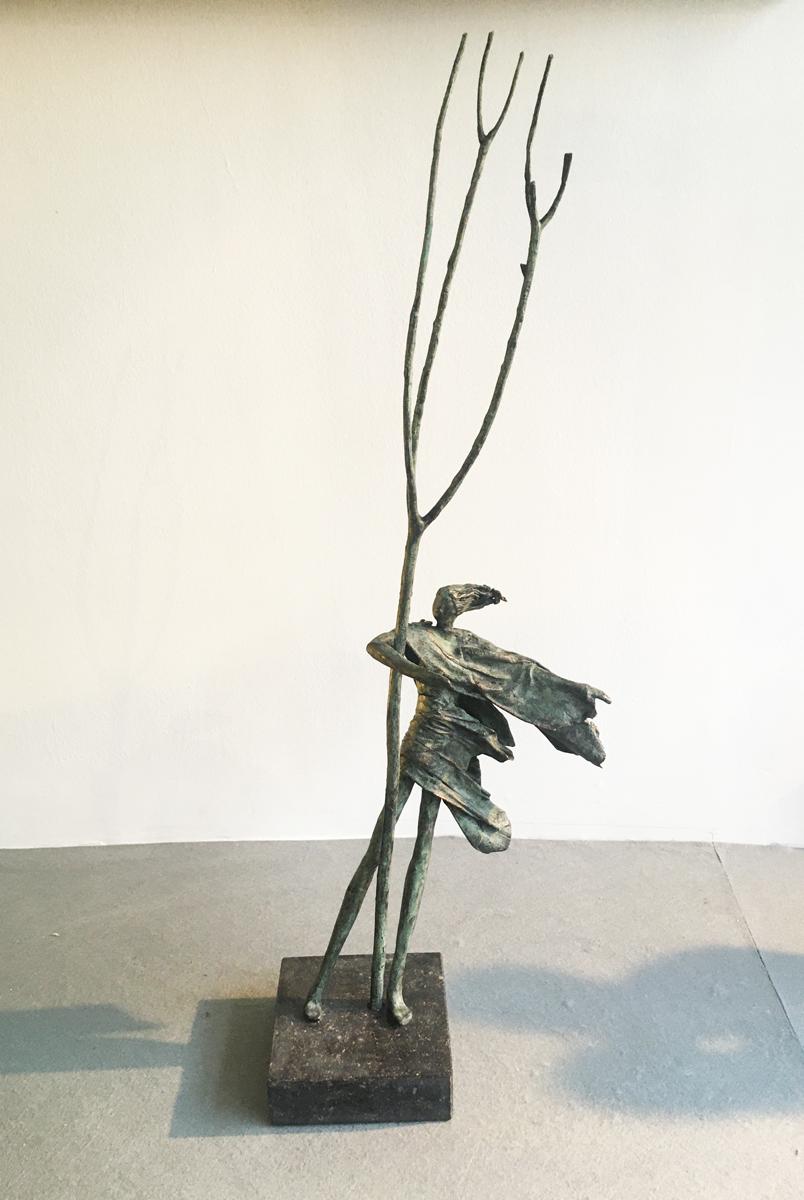 Anke Birnie Figurative Sculpture - Hold Tight - contemporary figurative standing female bronze sculpture tree windy
