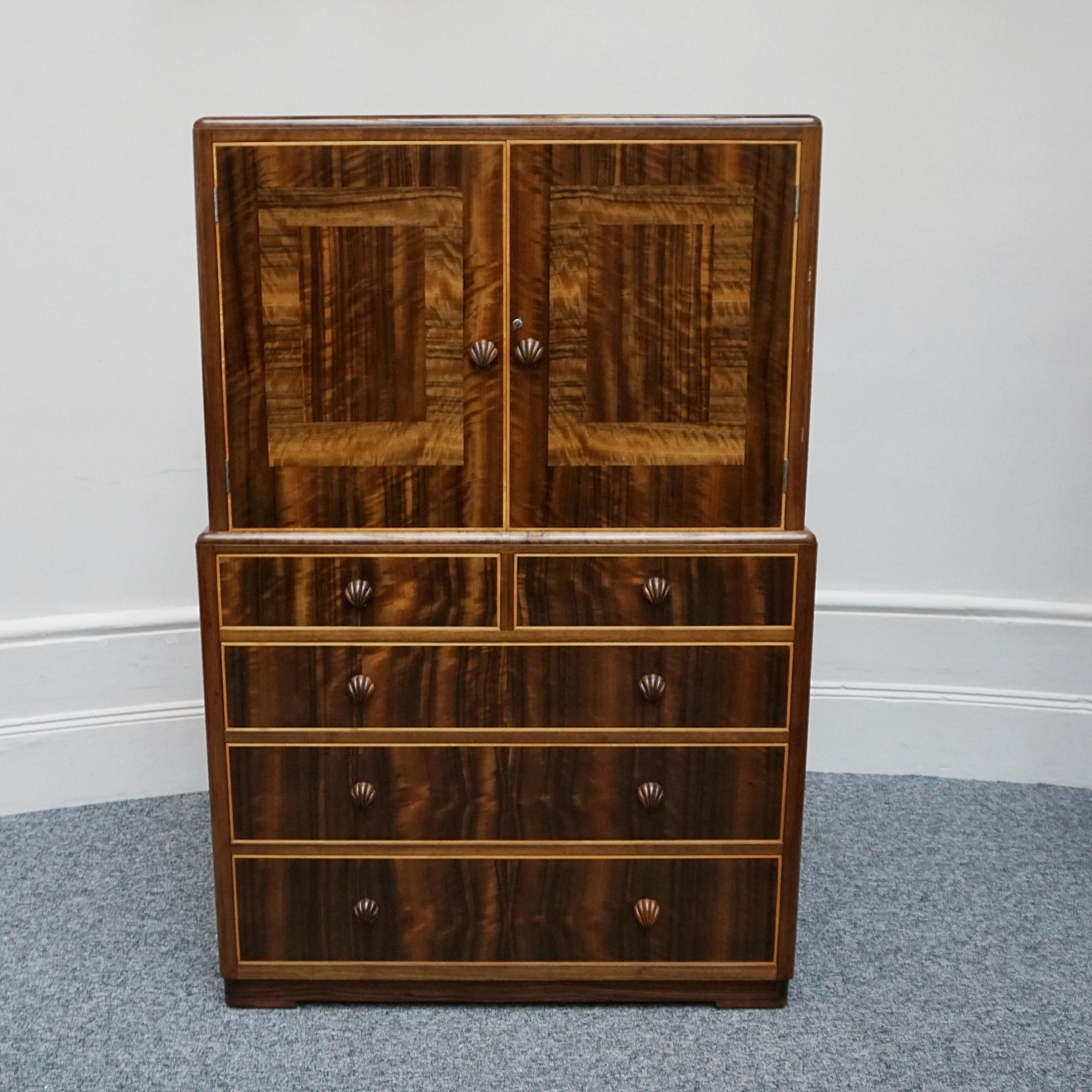 Art Deco Linen Cabinet by Betty Joel. Upper shelved cabinet above with an assortment of drawers below. Walnut and macassar ebony with original carved shell handles. Stamped signed and dated with designer and makers signature. 

Dimensions: H 148cm W