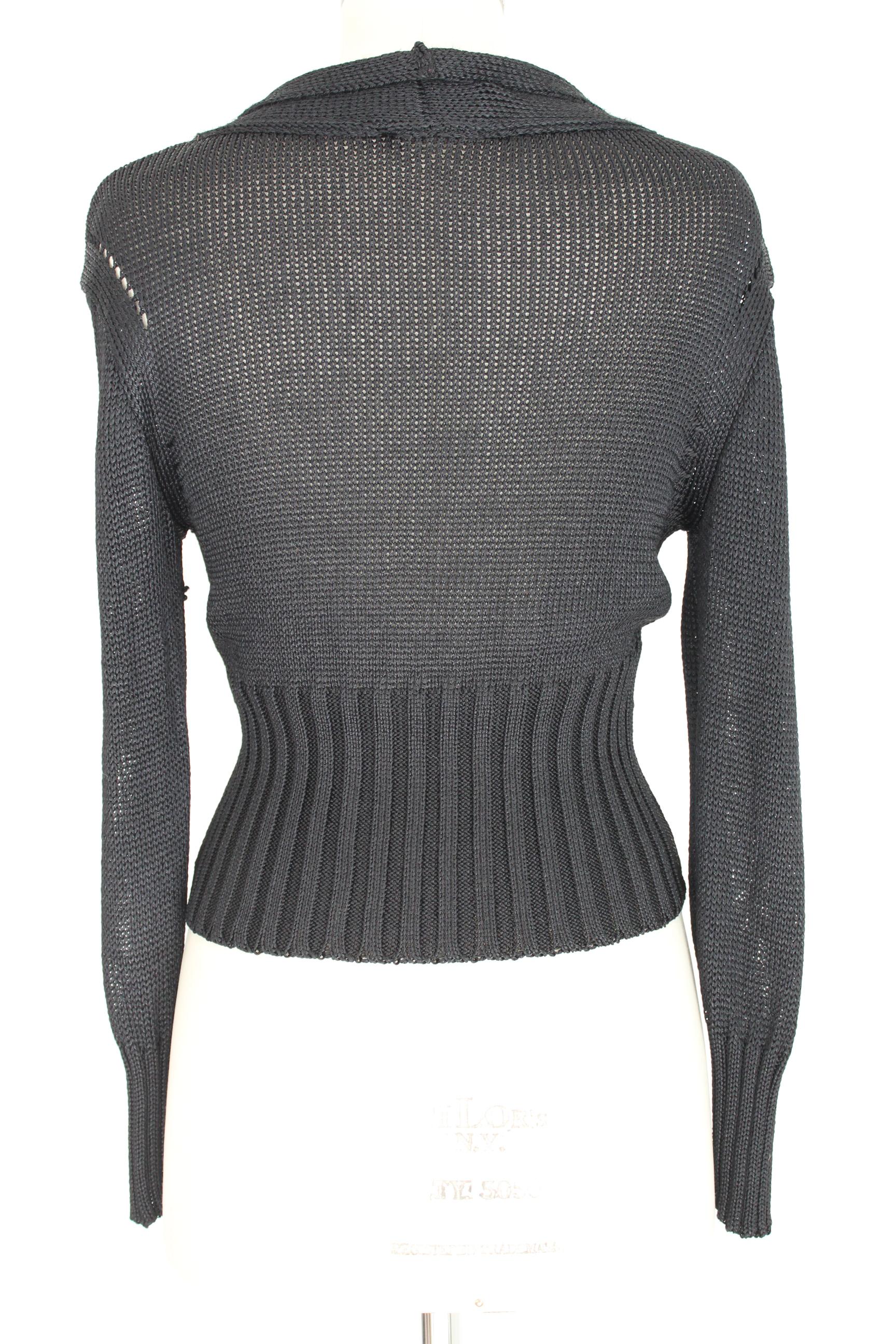 Ann Demeulemeester 90s vintage women's sweater. Cardigan color black openwork, deep neckline. 100% cotton . Short model on the sides. Made in Italy. Excellent vintage conditions.

Size: 40 It 6 Us 8 Uk

Shoulder: 40 cm

Bust/Chest: 45 cm

Sleeve: 60