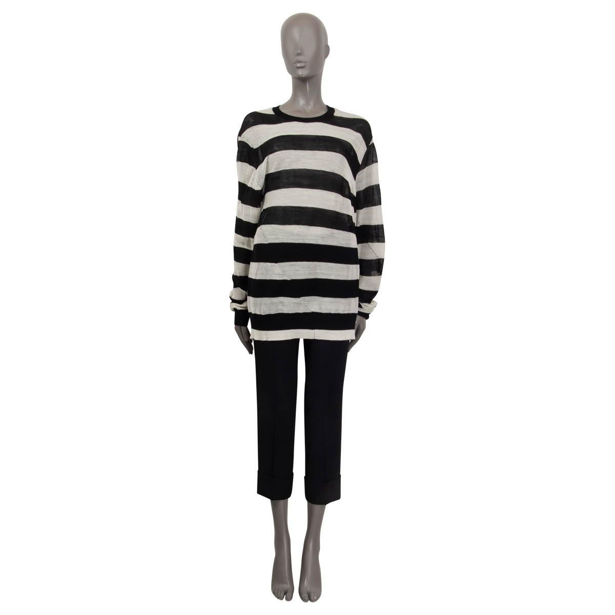 100% authentic Ann Demeulemeester striped wool sweater in black and white wool (100%). Features a semi-sheer appearance and is constructed with twisted seams. Has a crew neck, long sleeves and a loose fit. Has been worn and is in excellent
