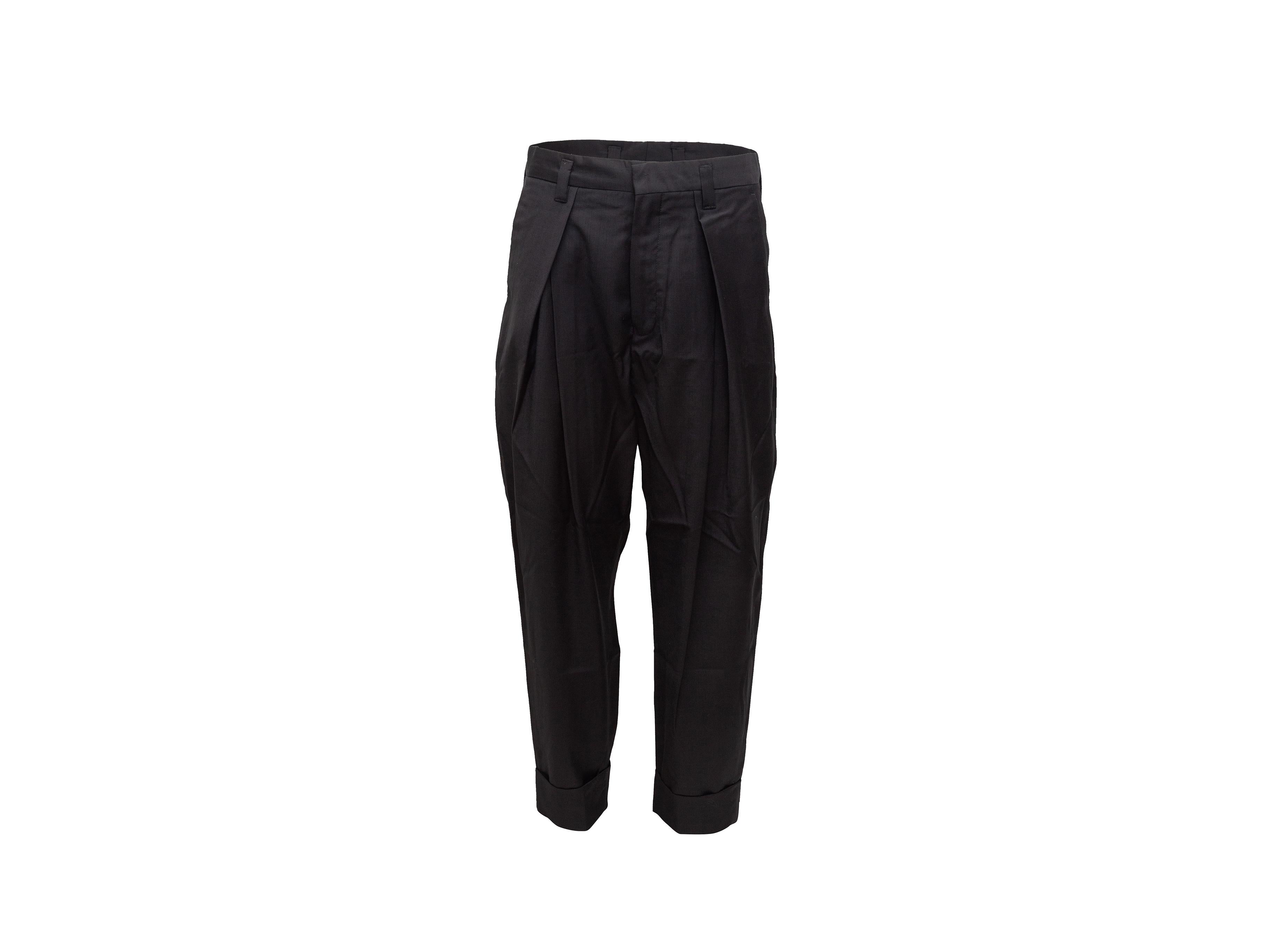 Product details: Black pleated wool trousers by Ann Demeulemeester. Four pockets. Zip closure at front. 32