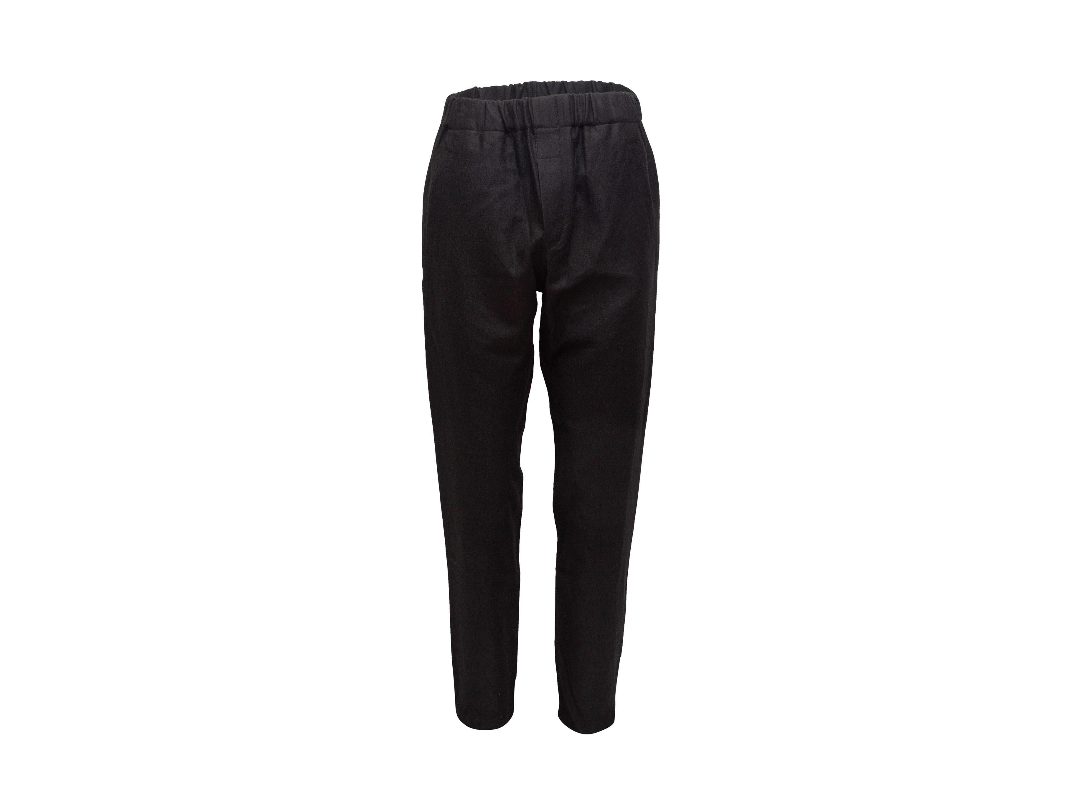 Product details: Black virgin wool pants by Ann Demeulemeester. Elasticized waistband. Dual hip pockets. Dual patch pockets at back. 30