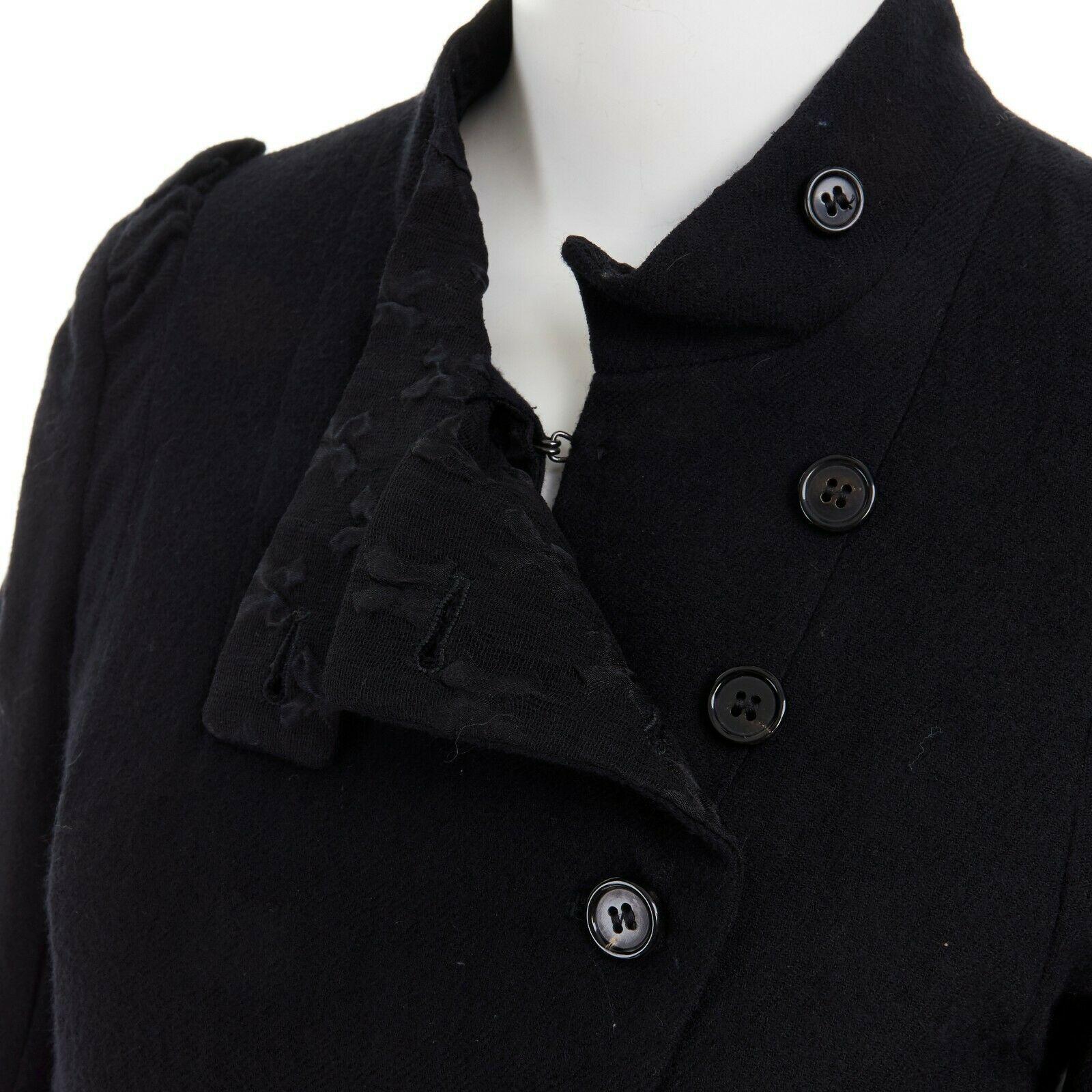 ANN DEMEULEMEESTER black wool asymmetric button ruched military jacket FR36 S

ANN DEMEULEMEESTER
100% virgin wool. Black outer. Cross jacquard mesh lining. Asymmetric button front closure. Button and hook eye closure. Ruched detail at shoulder.