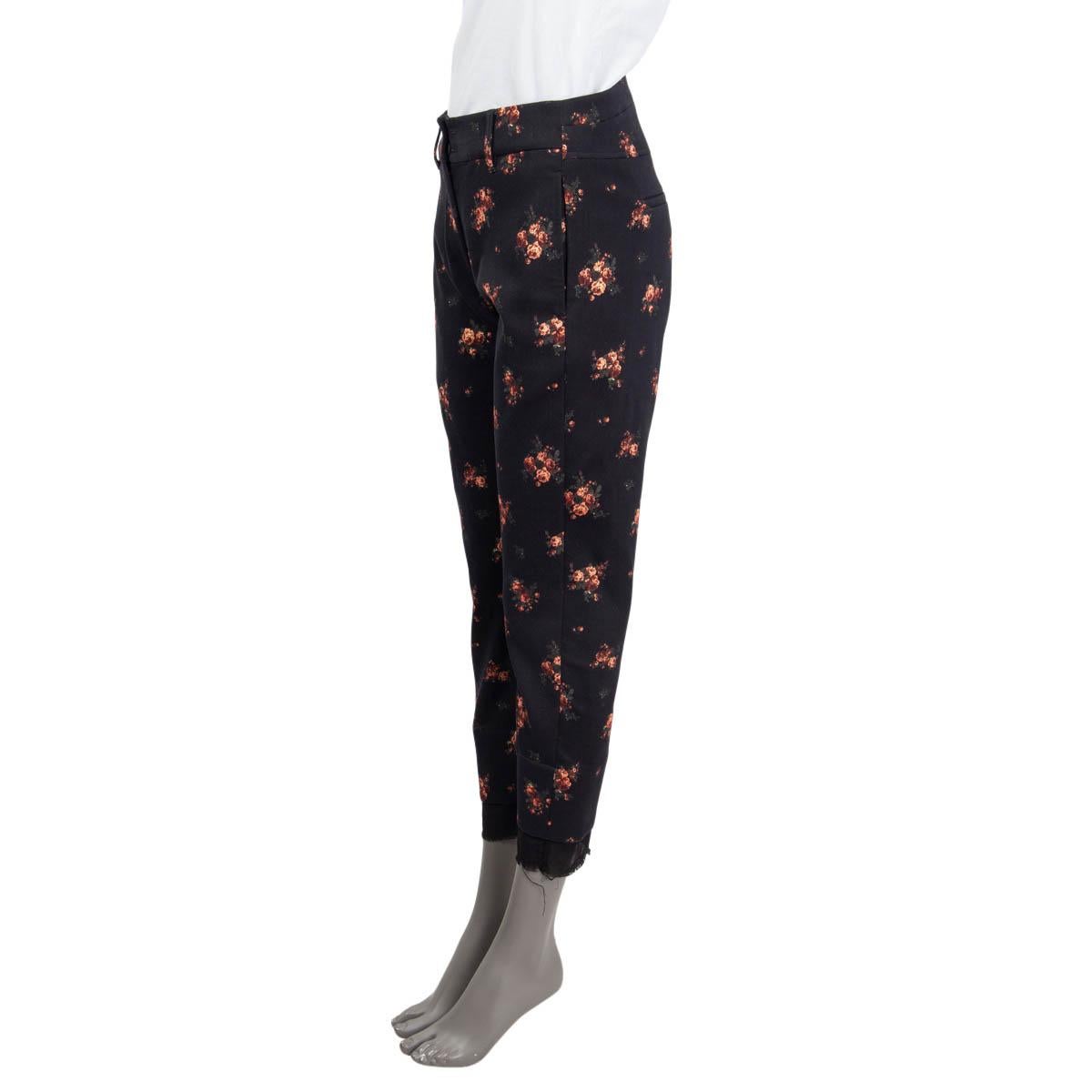 100% authentic Ann Demeulemeester 'Winona' pants in black cotton(54%), nylon (35%), spandex (6%) and polyester (5%). Feature a rose print, belt loops and the hem features a sheer black lining. Have two slit pockets on the sides and two slit pockets