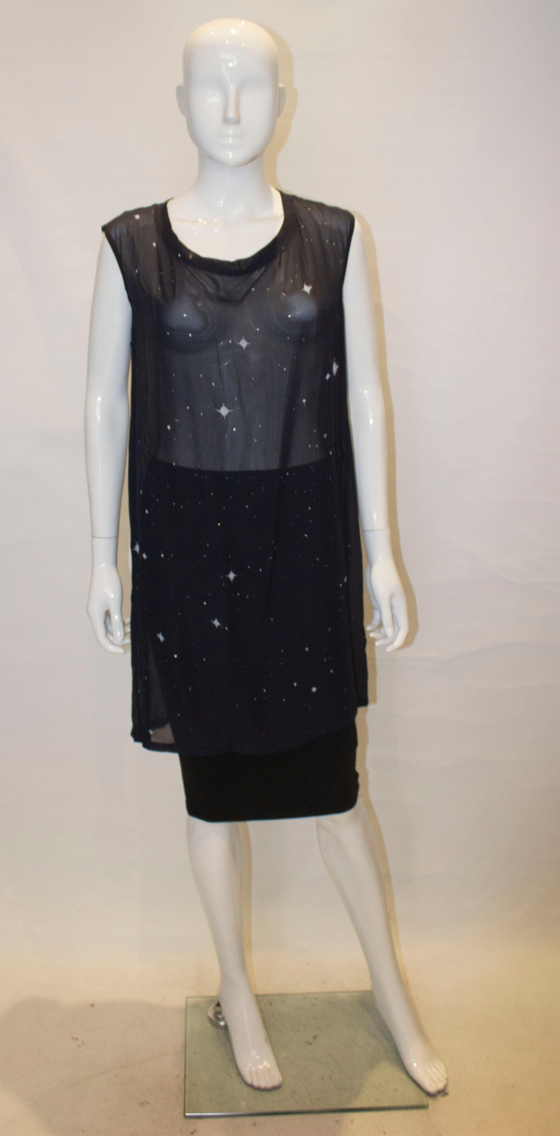 An attractive silk top by Ann Demeukemeester. In a blue silk , the top has decoration on the front and has a round neckline.
